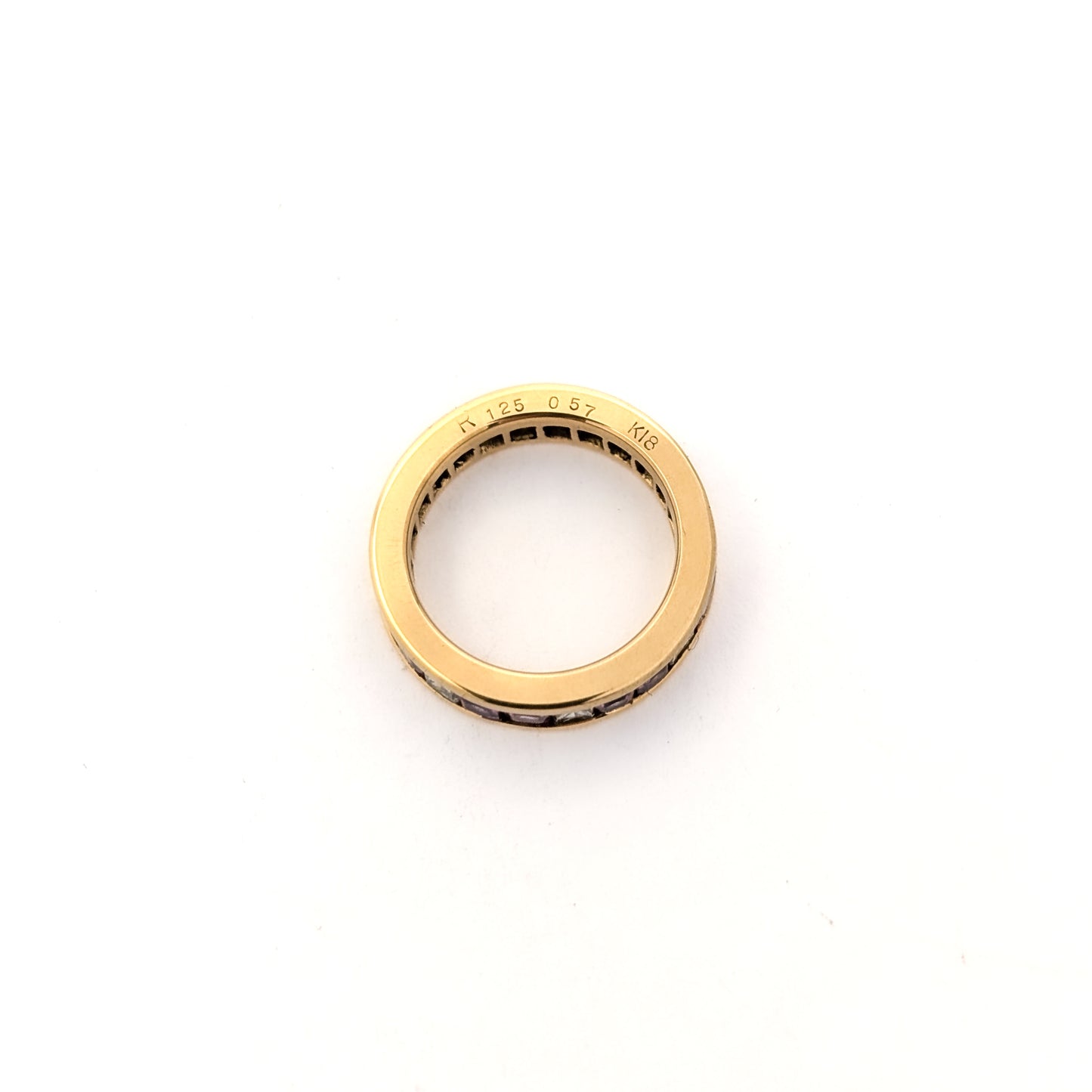 14k gold eternity band with pink sapphires and diamonds on a white background