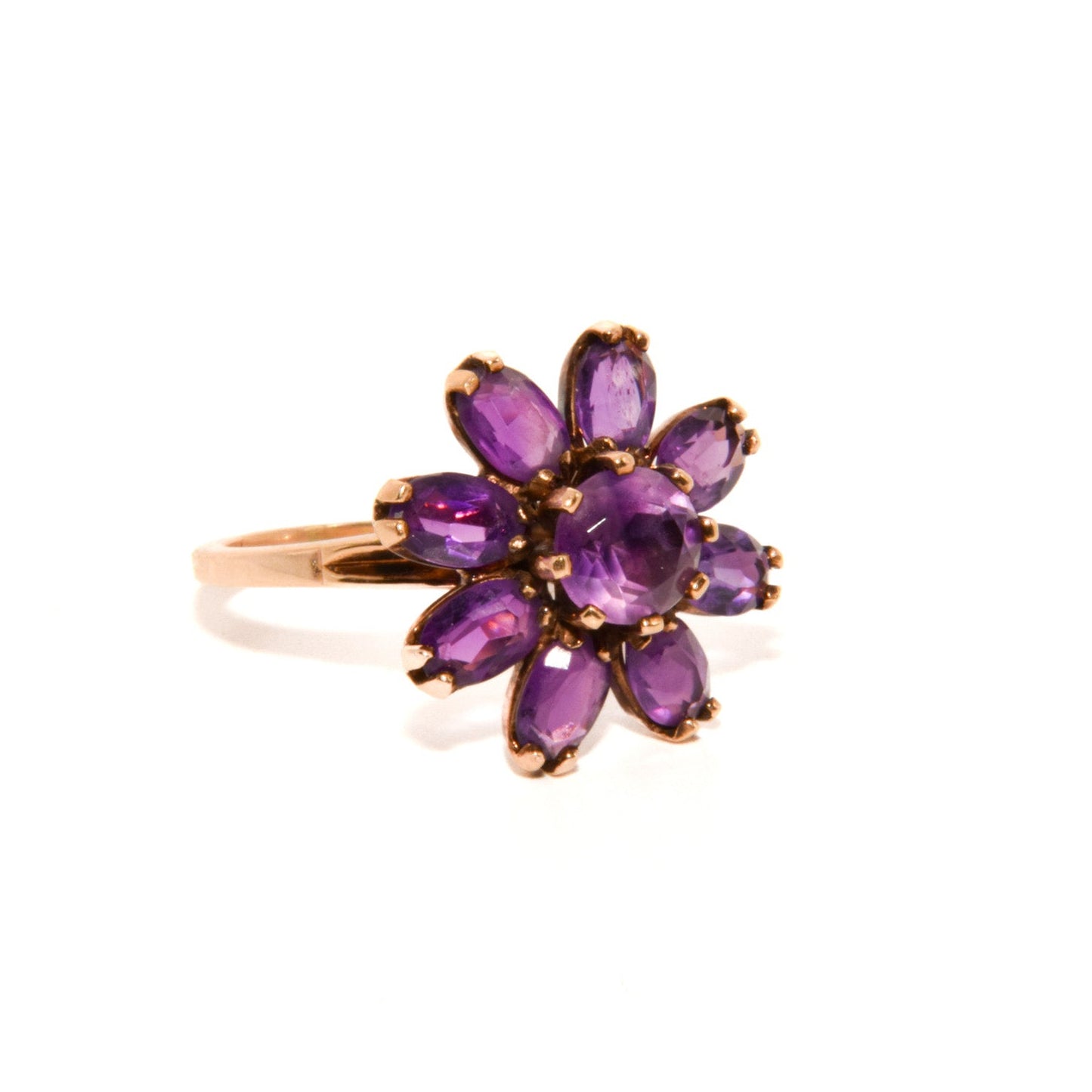 Vintage 14k Gold Amethyst Cluster Ring. Featuring a striking arrangement of deep purple amethysts, this bold ring demands attention with its vibrant purple tones and intricate craftsmanship.