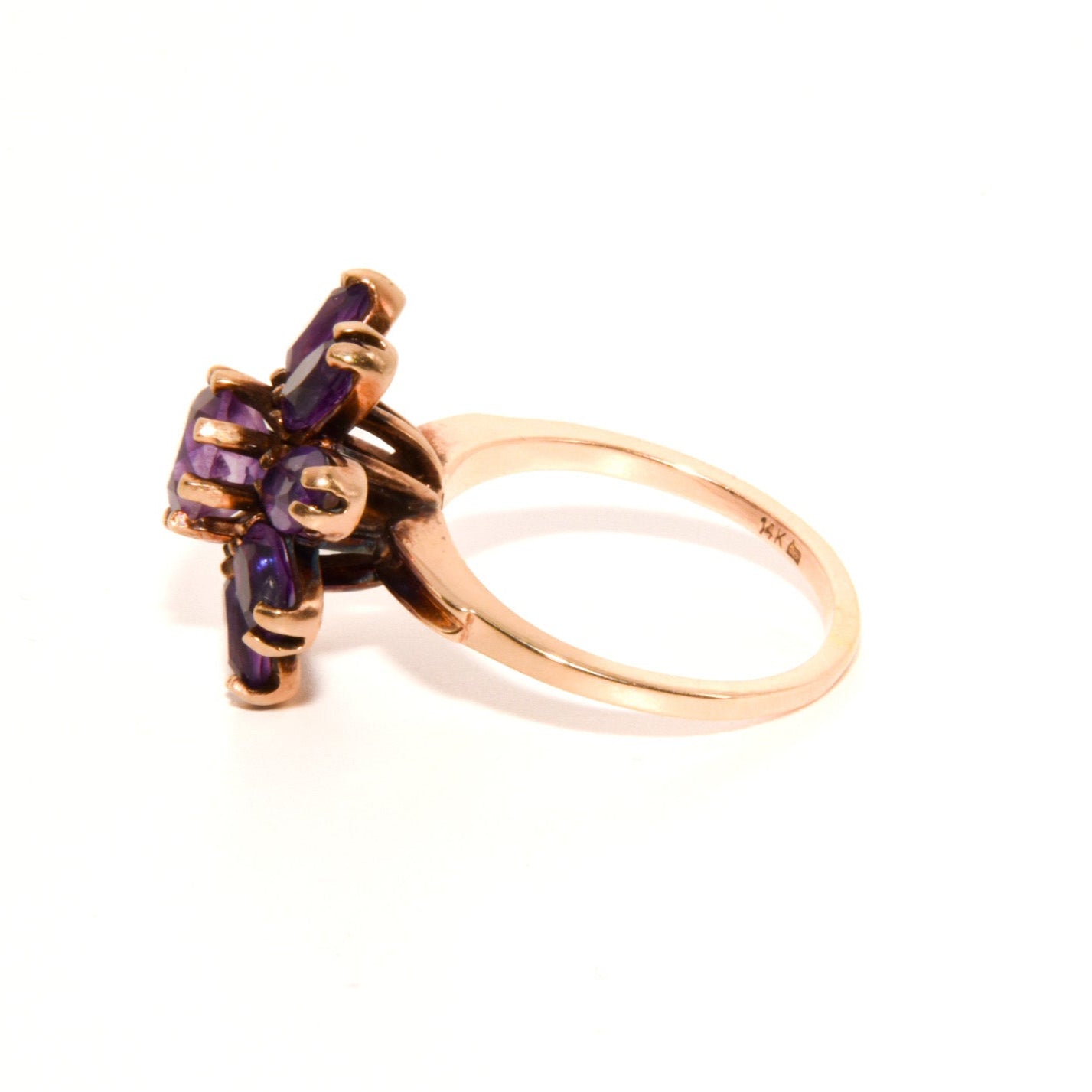 Vintage 14k Gold Amethyst Cluster Ring. Featuring a striking arrangement of deep purple amethysts, this bold ring demands attention with its vibrant purple tones and intricate craftsmanship.