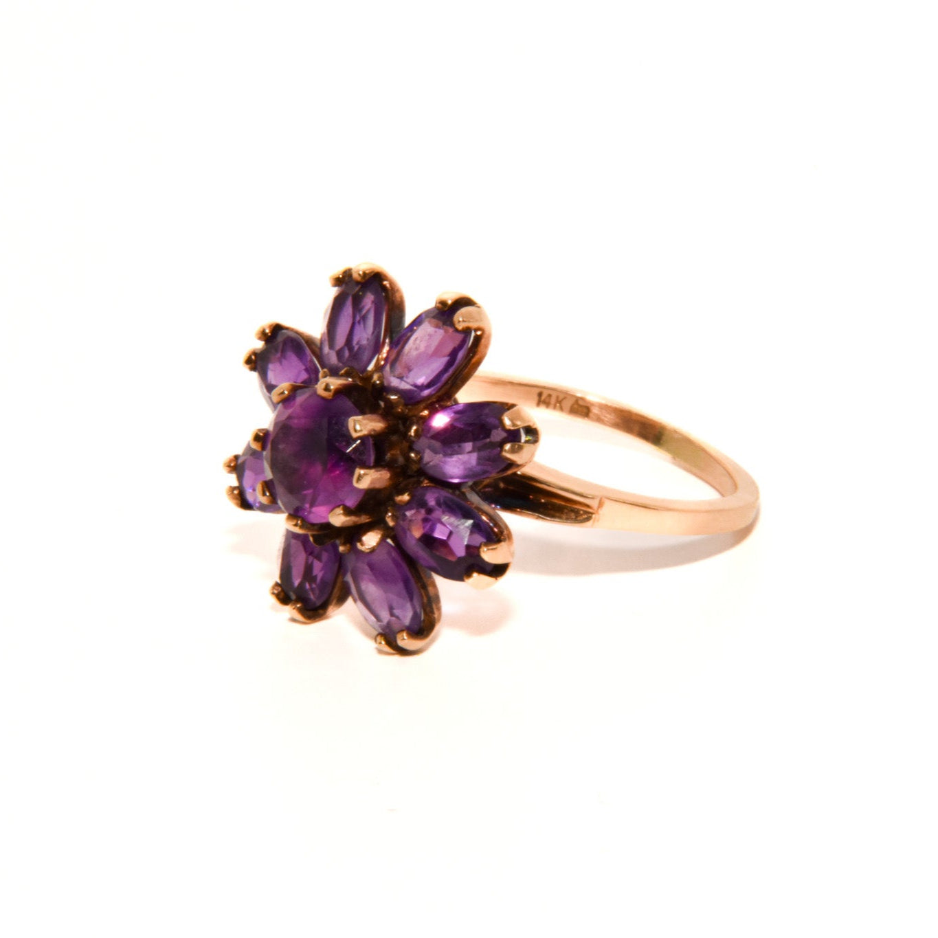 Vintage 14k Gold Amethyst Cluster Ring. Featuring a striking arrangement of deep purple amethysts, this bold ring demands attention with its vibrant purple tones and intricate craftsmanship.