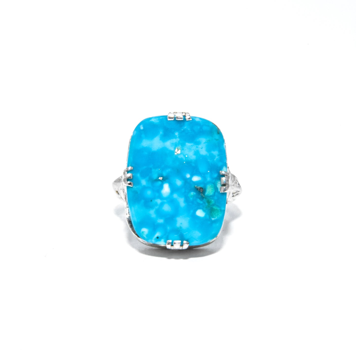 An Art Deco style 14K white gold ring with a large turquoise stone and intricate filigree design.