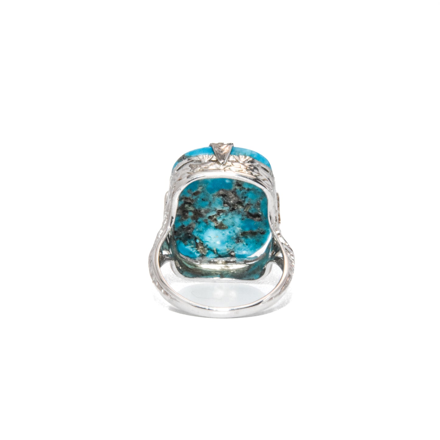 An Art Deco style 14K white gold ring with a large turquoise stone and intricate filigree design.