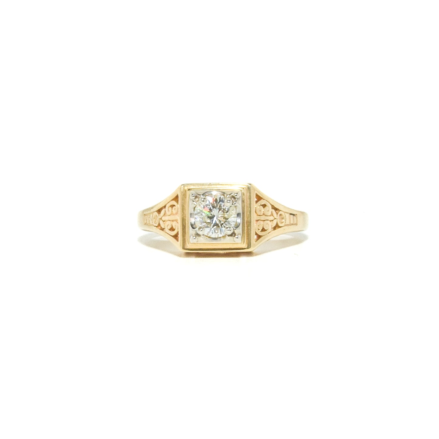 A vintage 14K gold diamond ring with ornate filigree work, featuring a round brilliant cut diamond set in a yellow gold mounting.