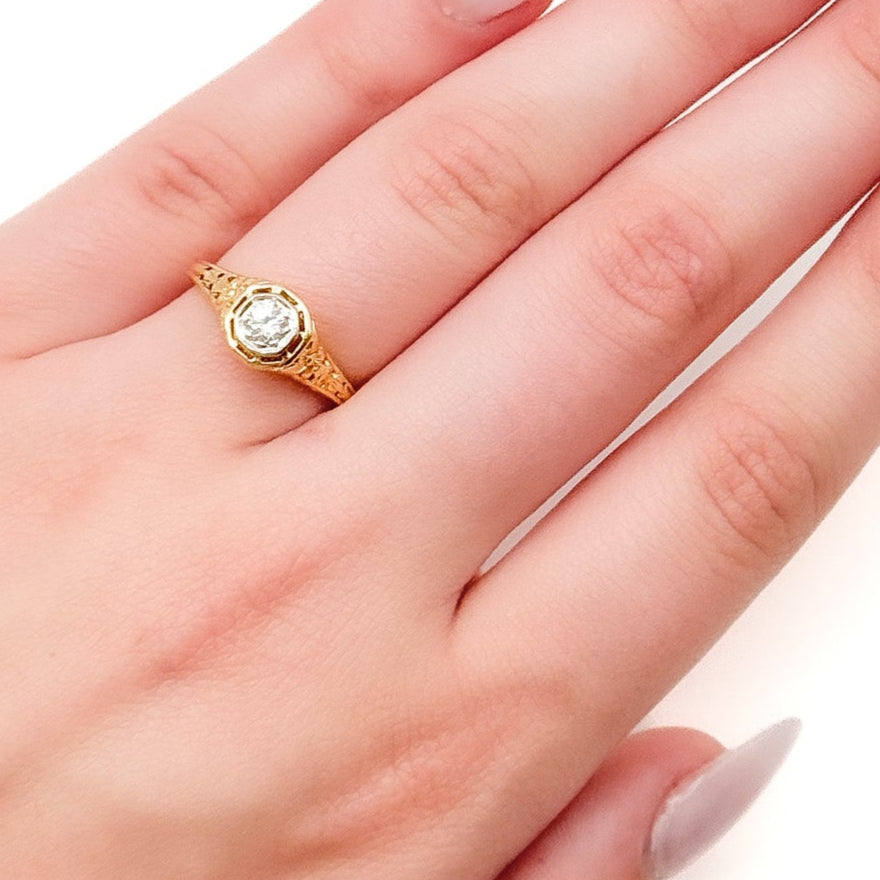 Antique Art Deco Diamond Filigree Ring. Featuring a dazzling diamond amidst an intricately detailed filigree design.