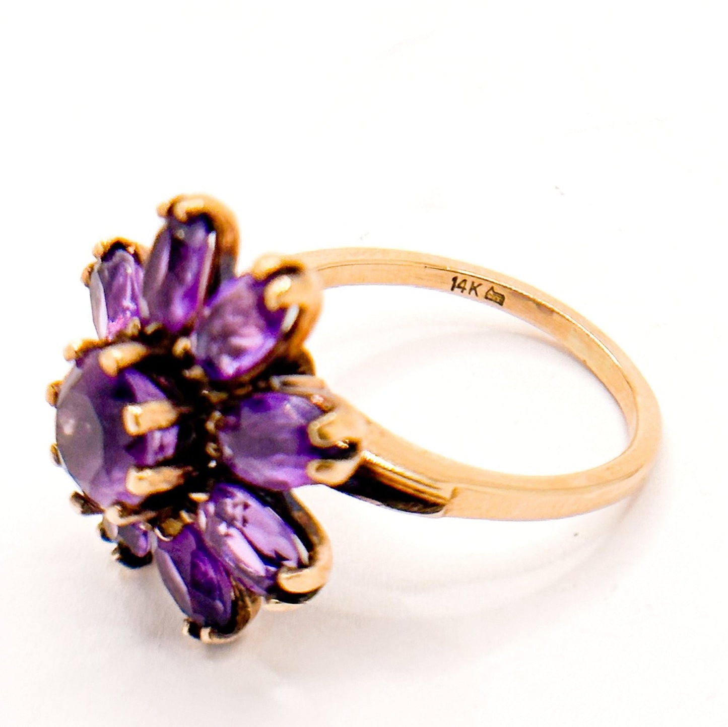 Vintage 14k Gold Amethyst Cluster Ring. Featuring a striking arrangement of deep purple amethysts, this bold ring demands attention with its vibrant purple tones and intricate craftsmanship.