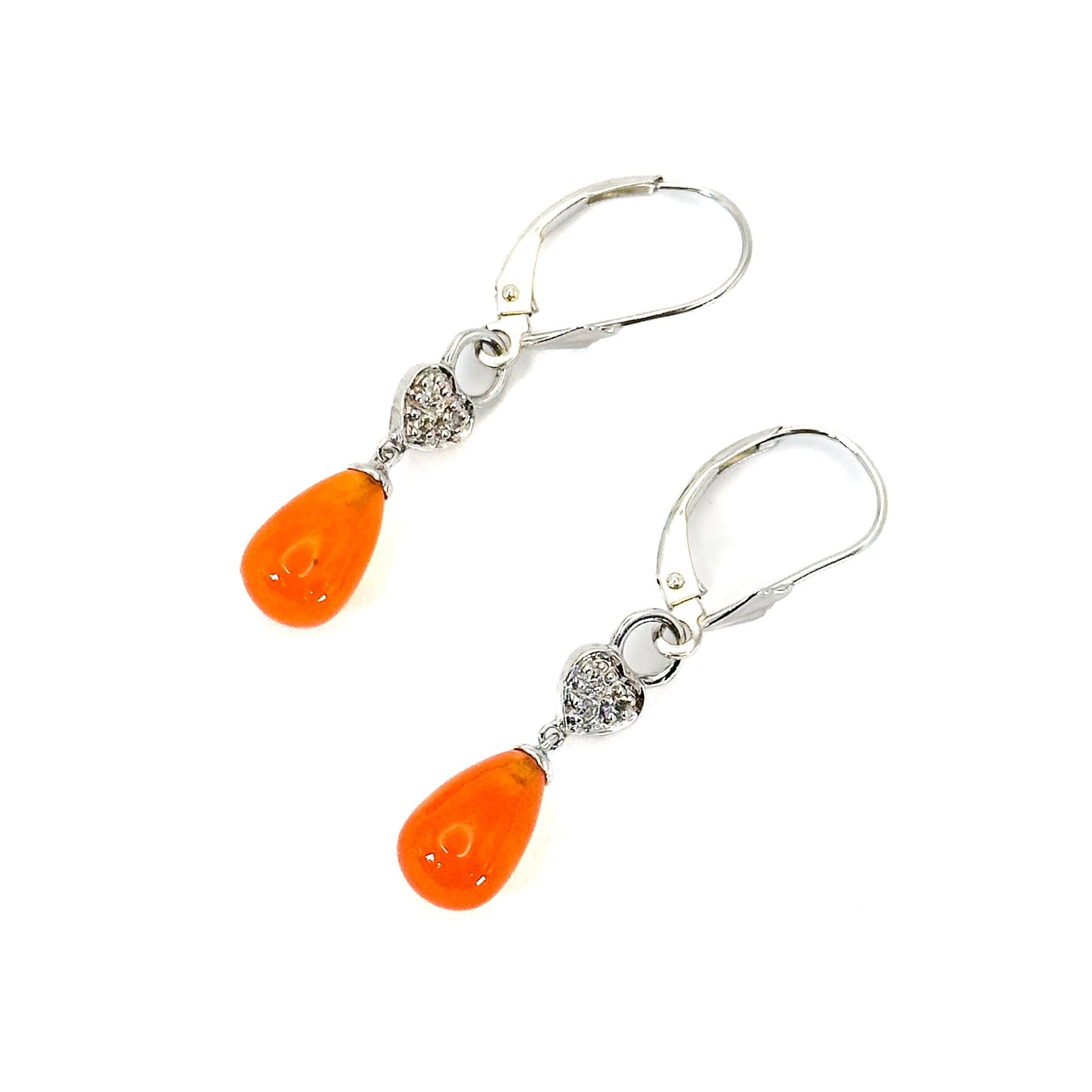 A pair of 14K white gold dangle lever-back earrings featuring teardrop-shaped fire opals with heart-shaped and diamond accents accents on a white background.