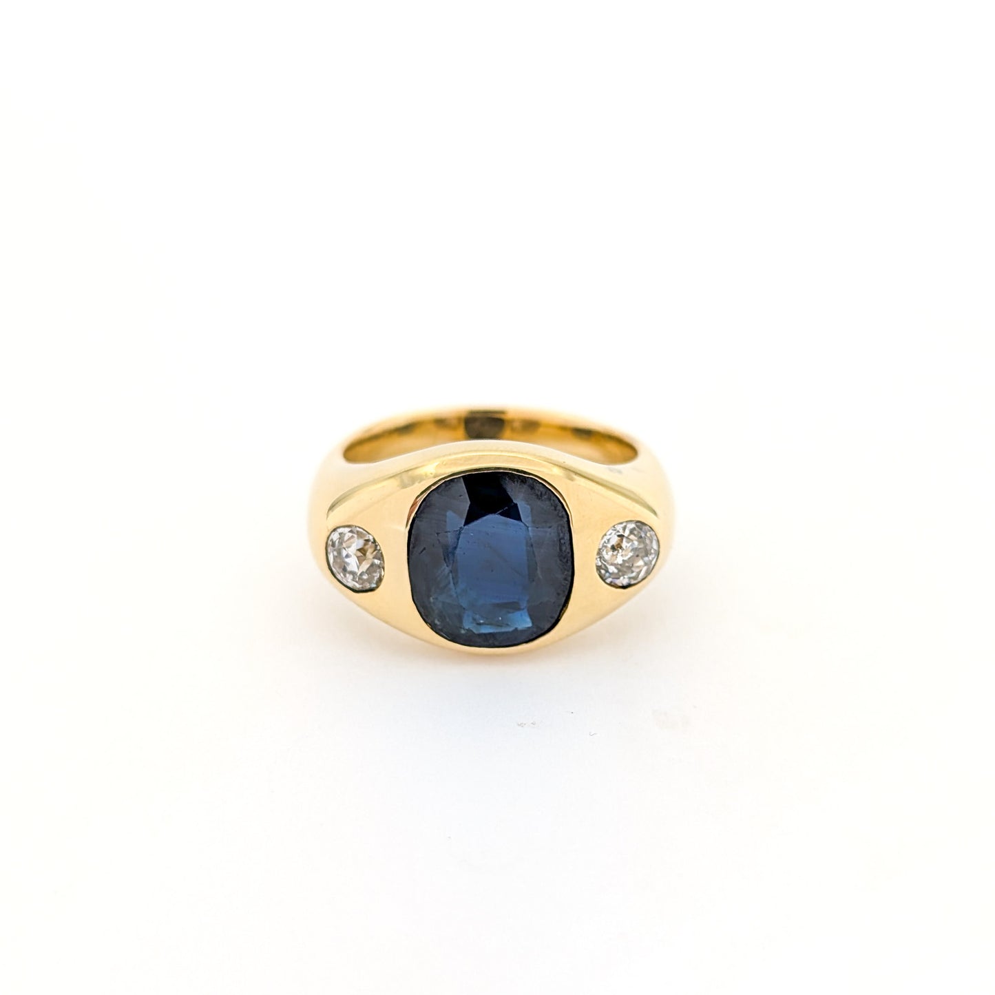 Italian crafted Antique Cushion Cut Blue Sapphire and Old Mine Cut Diamonds Dome Ring in 18K Gold with white background.