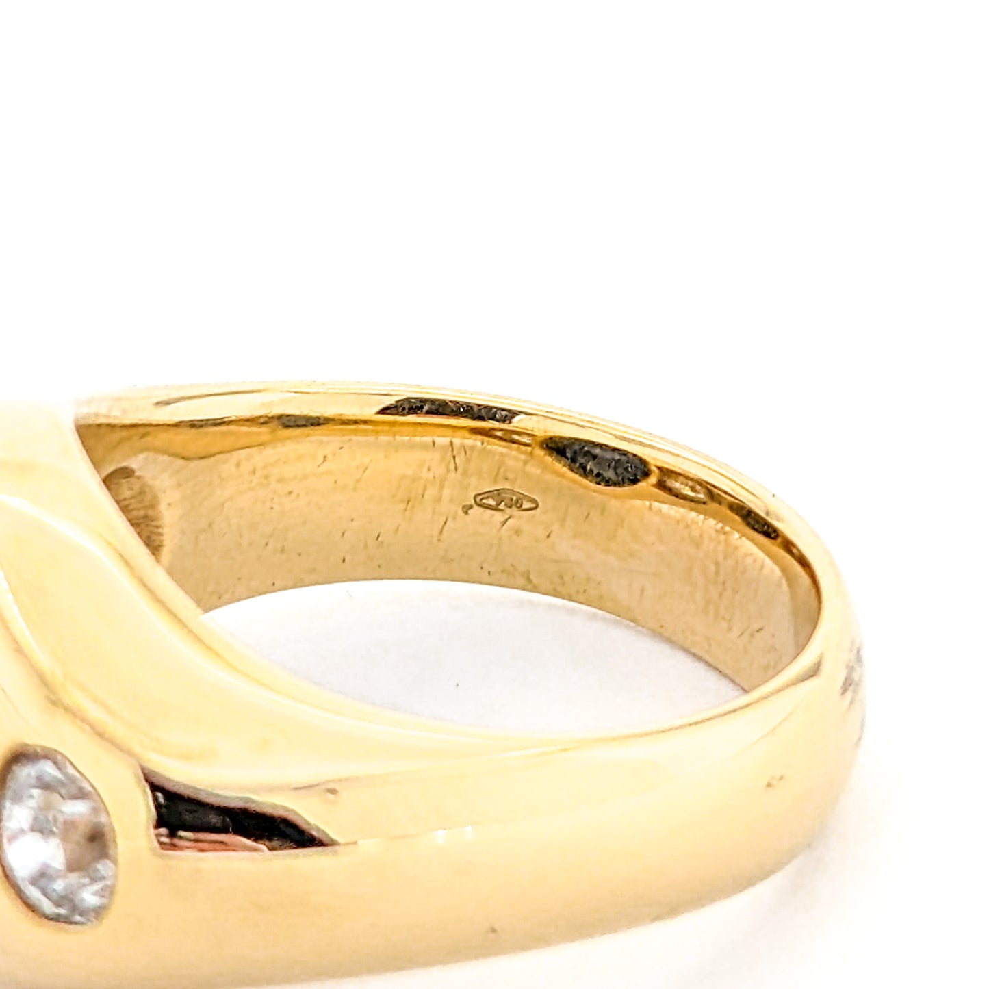 Gold ring with a diamond on a white background