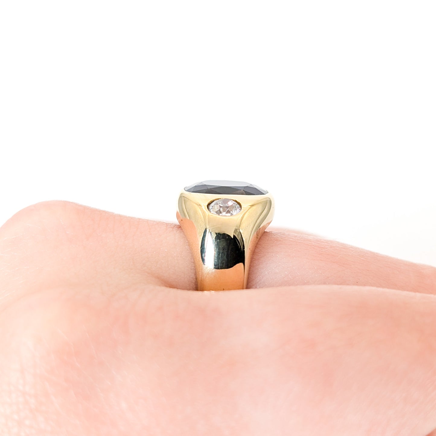 Italian crafted Antique Cushion Cut Blue Sapphire and Old Mine Cut Diamonds Dome Ring in 18K Gold with on a woman's hand white background