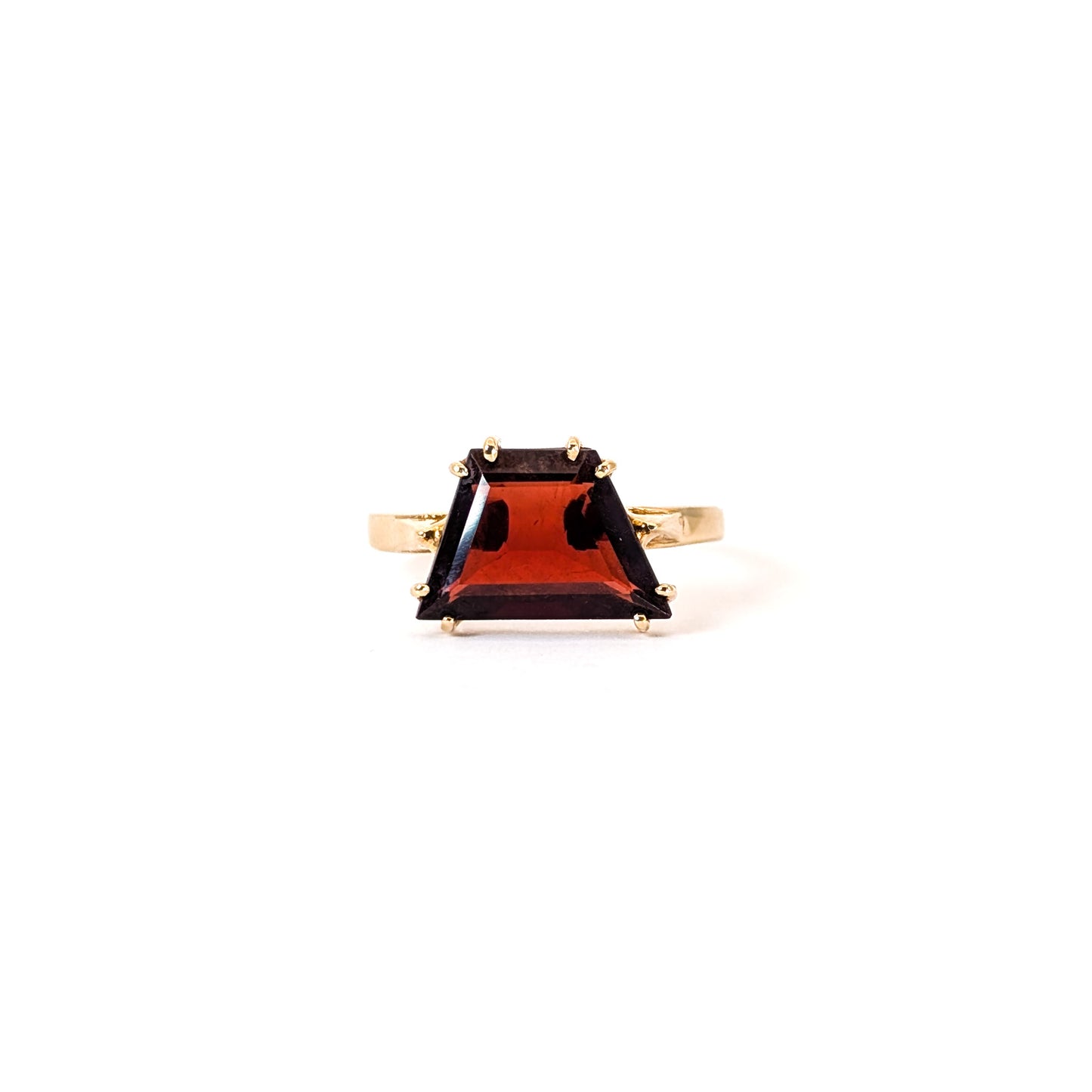 14K Gold garnet ring, cut into a striking trapezoid shape, on a white background