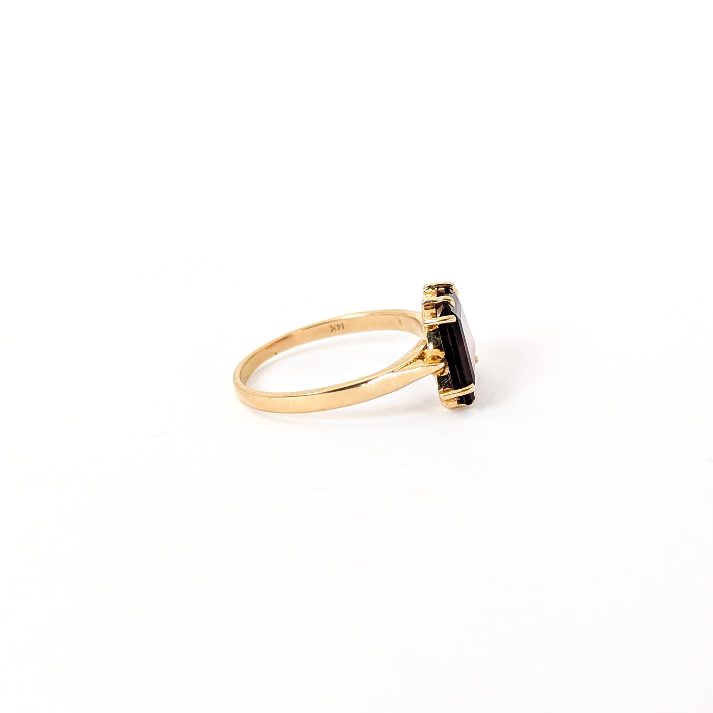 14K Gold garnet ring, cut into a striking trapezoid shape, on a white background