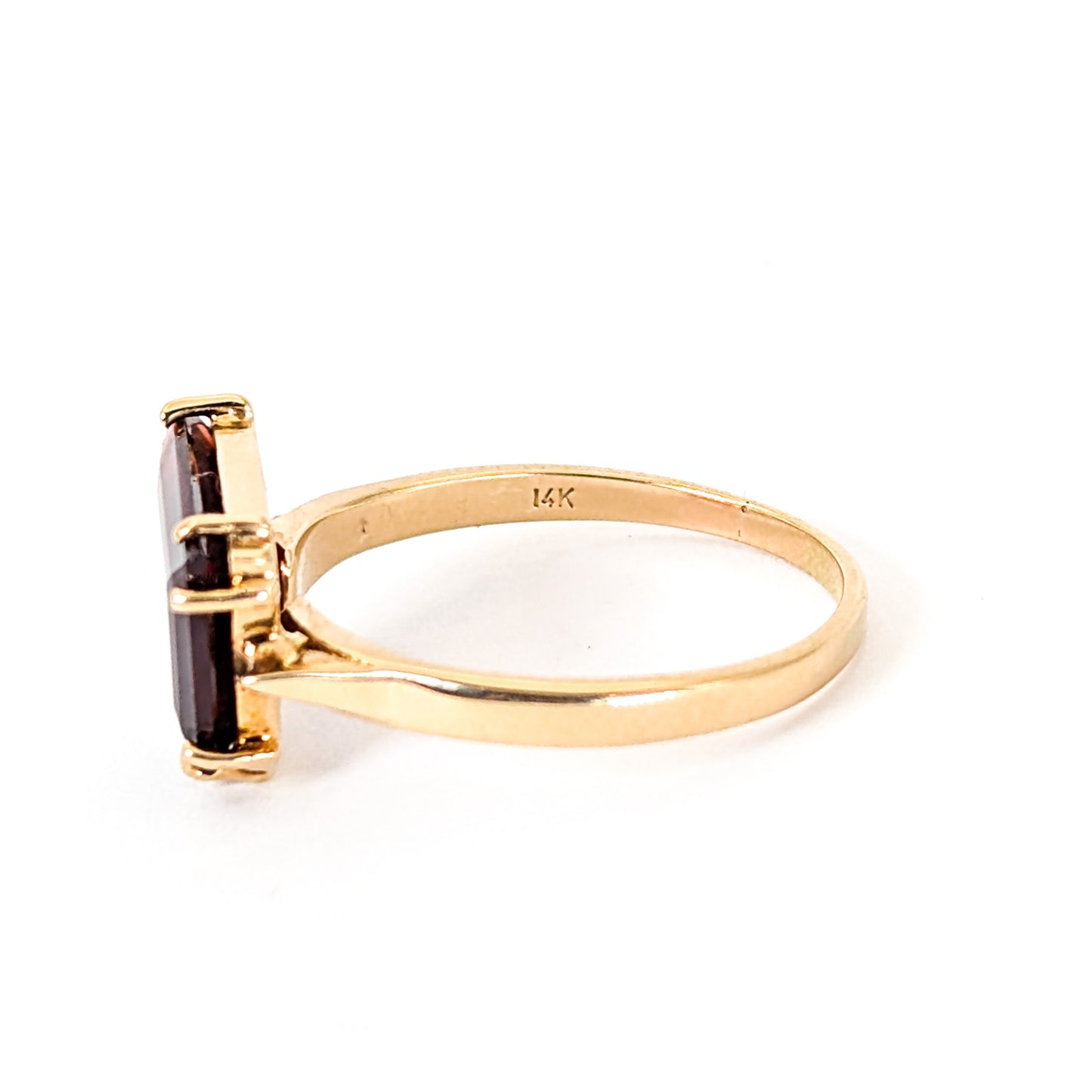 14K Gold garnet ring, cut into a striking trapezoid shape, on a white background