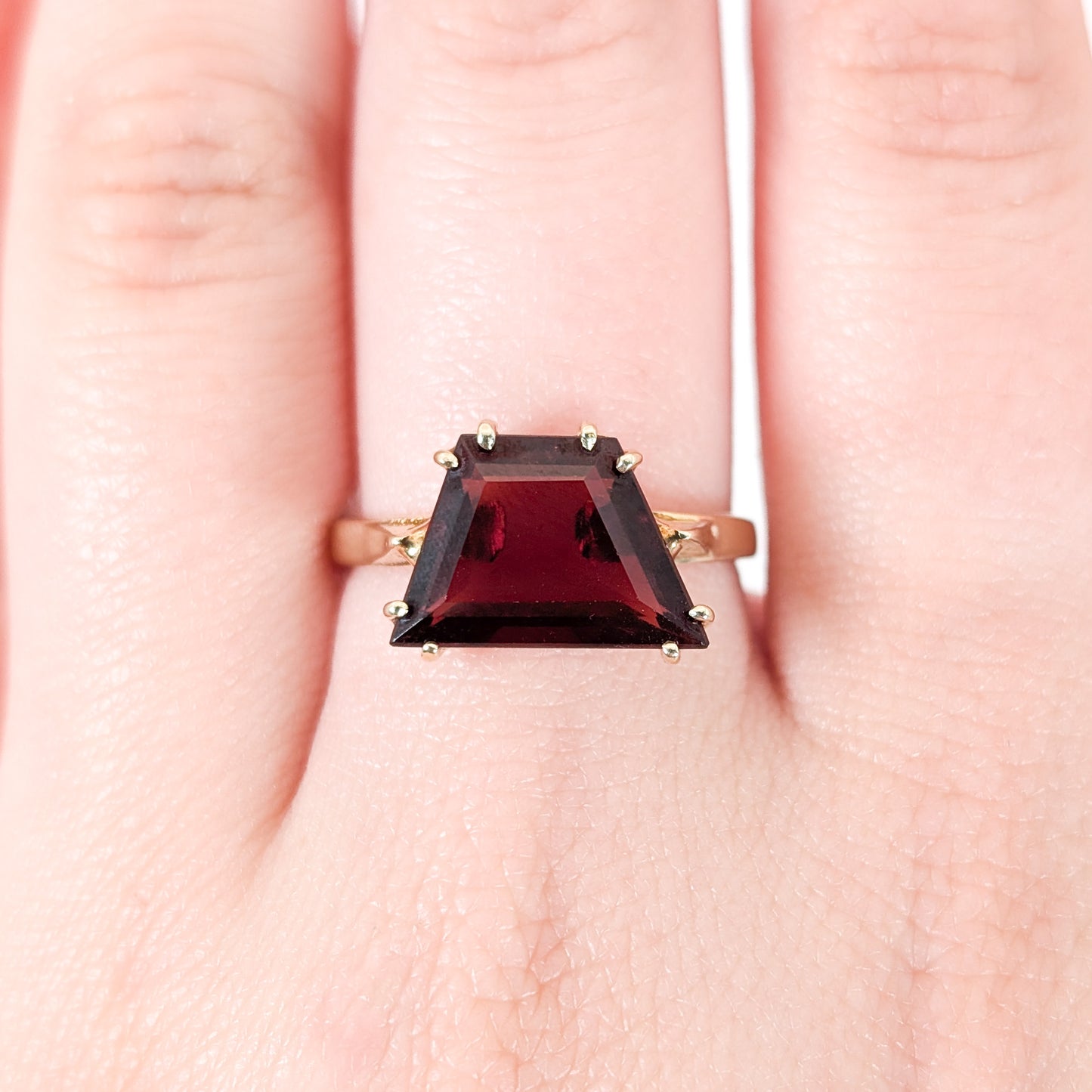 14K Gold garnet ring, cut into a striking trapezoid shape on a hand