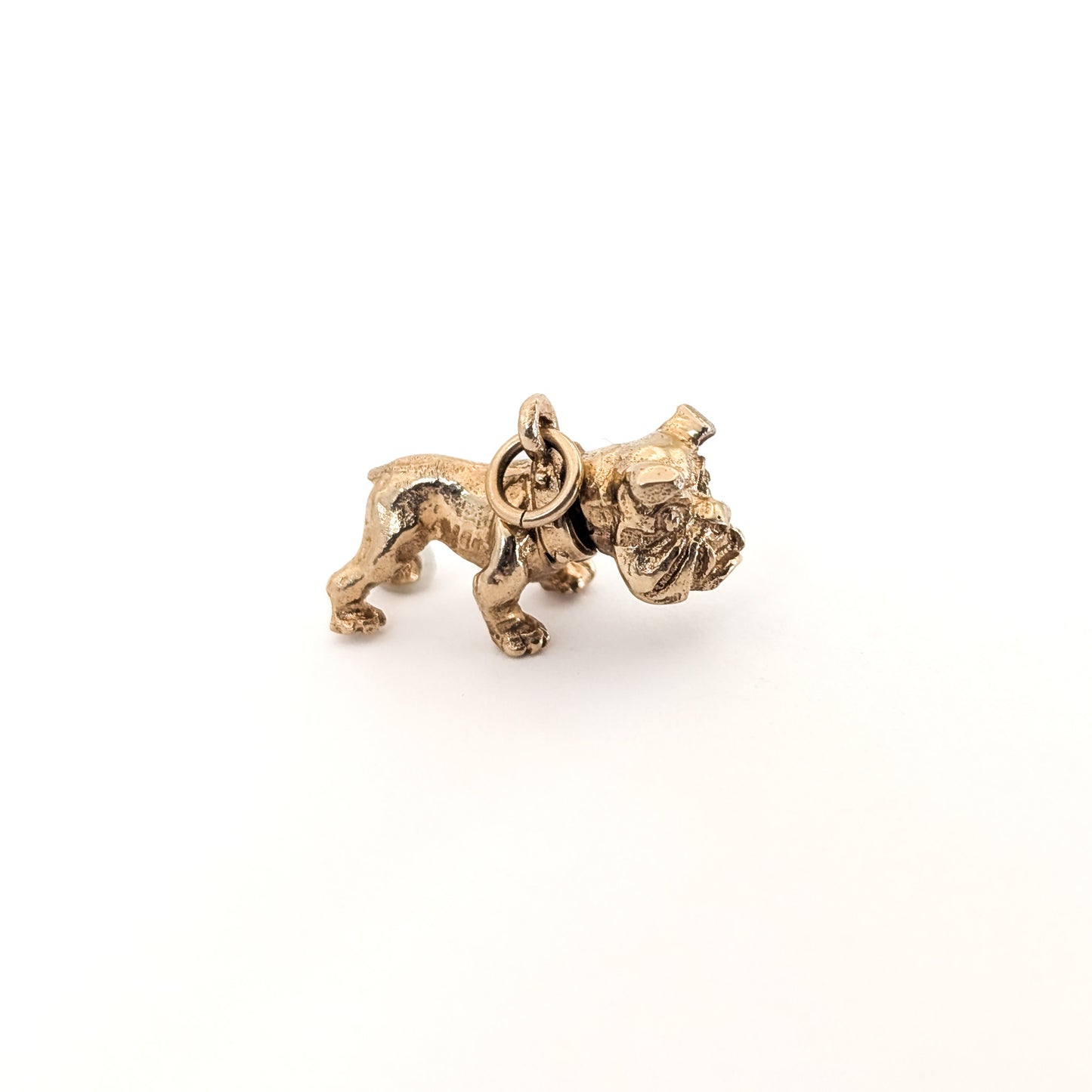 Vintage 14k Gold bulldog mechanical charm on a white background