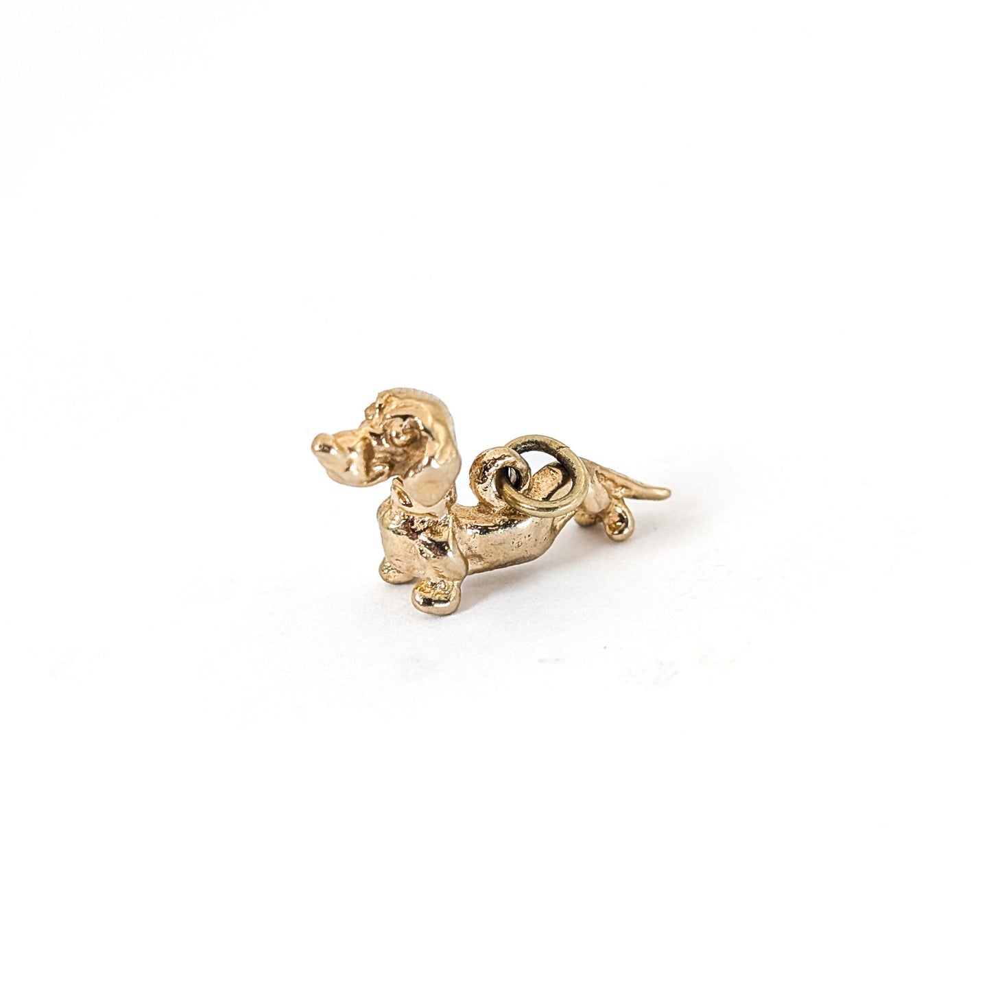14K Gold dachshund mechanical charm on a white background