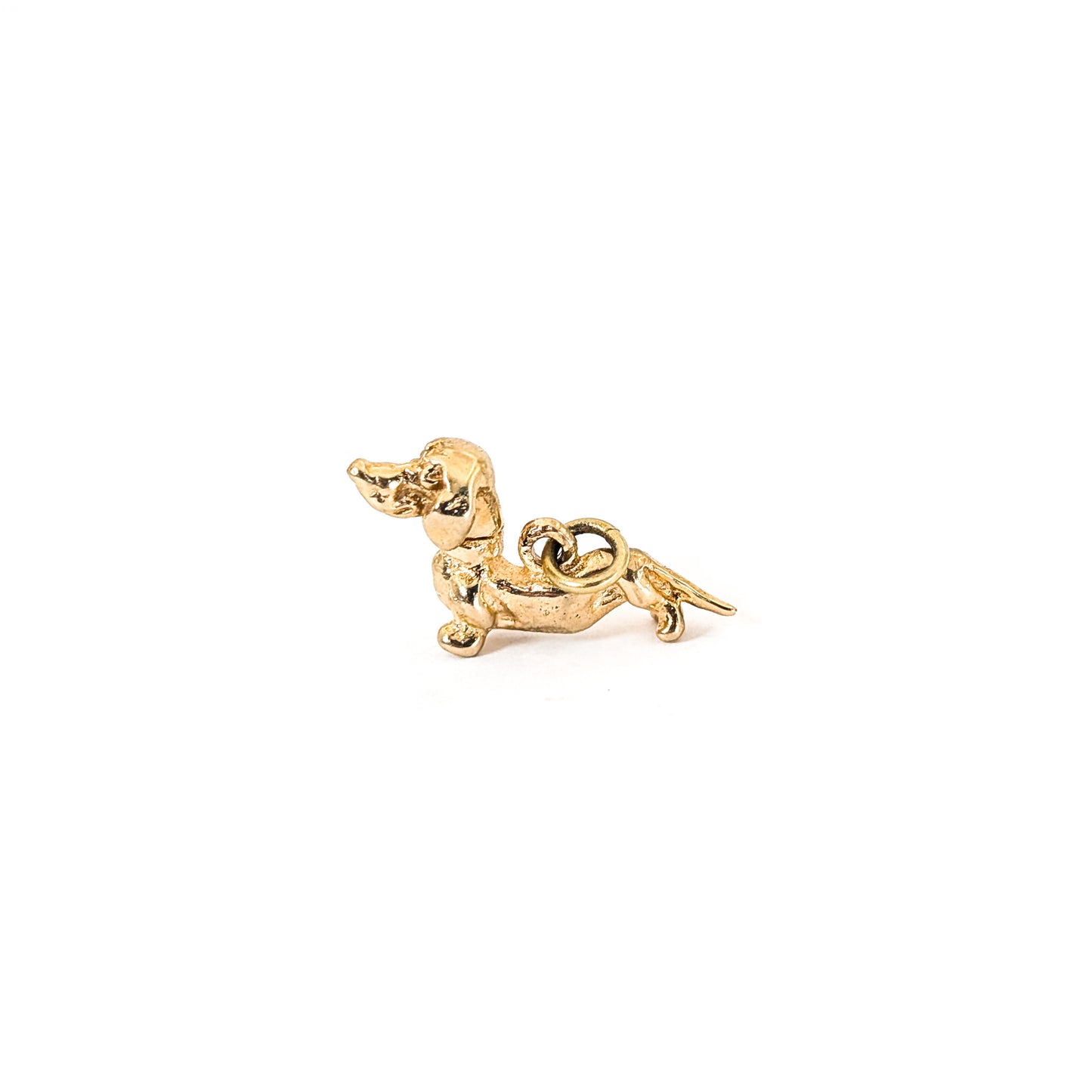 14K Gold dachshund mechanical charm on a white background