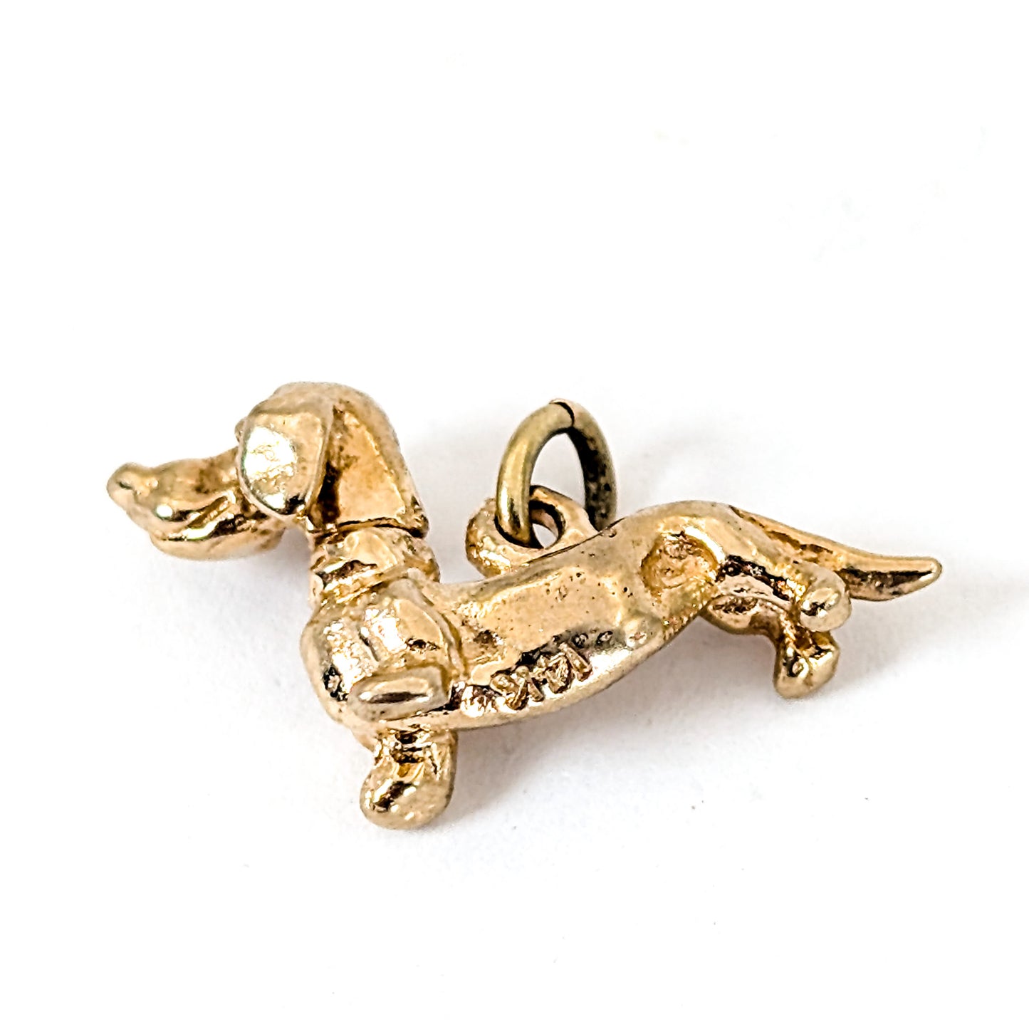 14K Gold dachshund mechanical charm on a white background