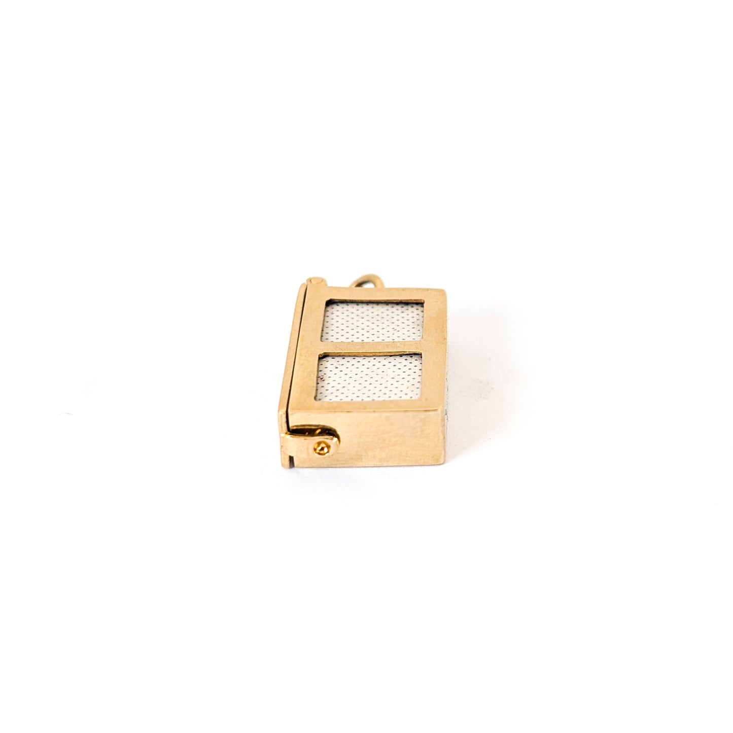 14k gold vintage mechanical charm with enameled card suit symbols and a real deck of cards on a white background