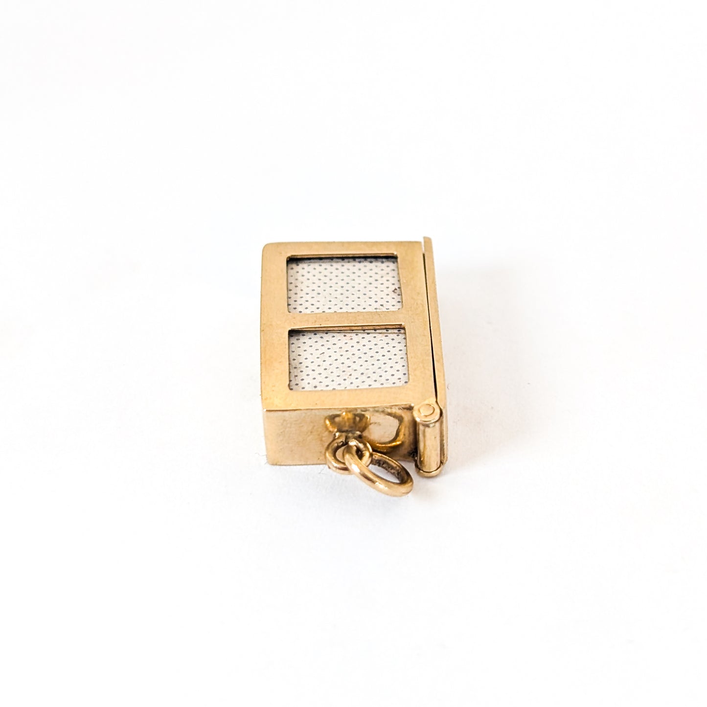 14k gold vintage mechanical charm with enameled card suit symbols and a real deck of cards on a white background