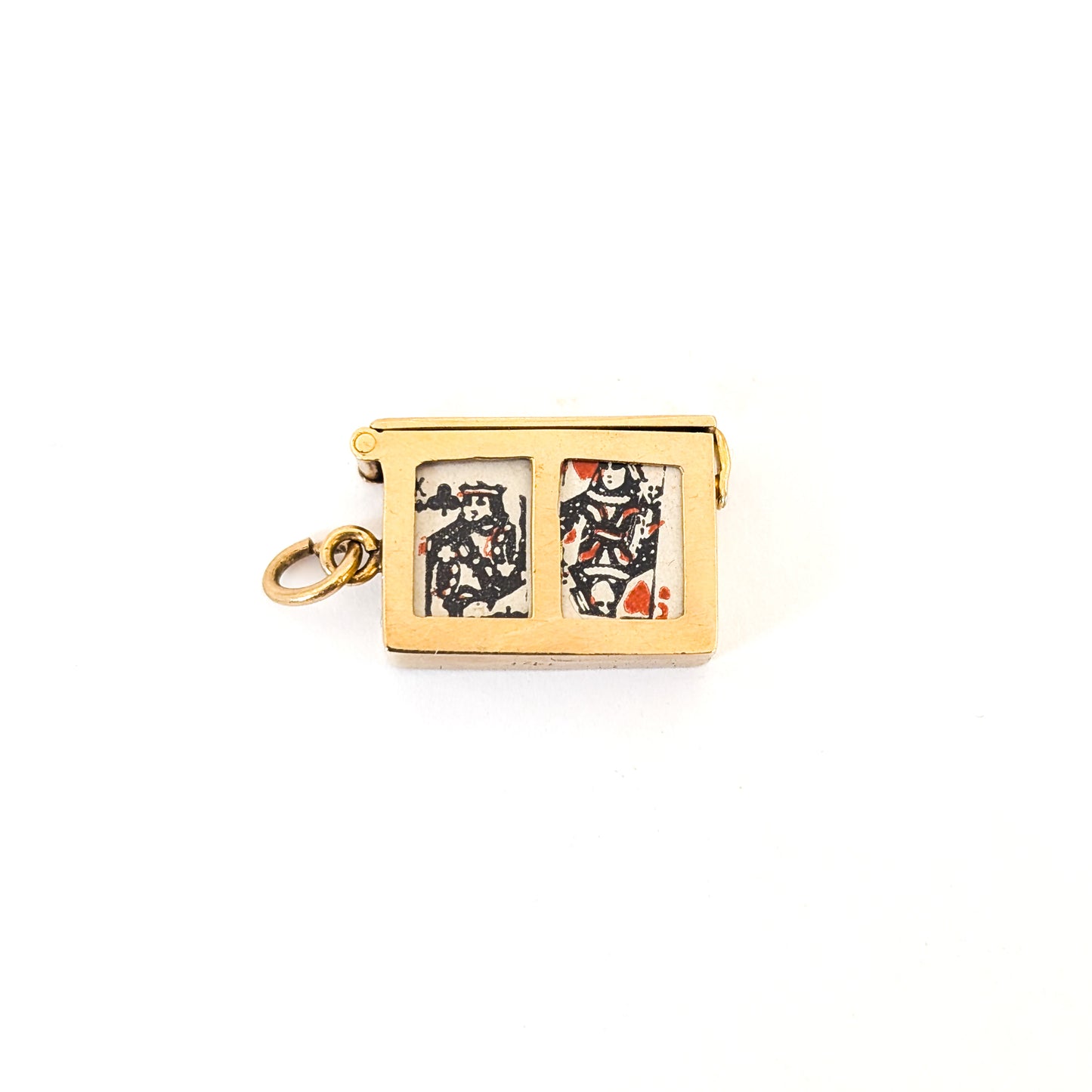 14k gold vintage mechanical charm with enameled card suit symbols and a real deck of cards on a white background