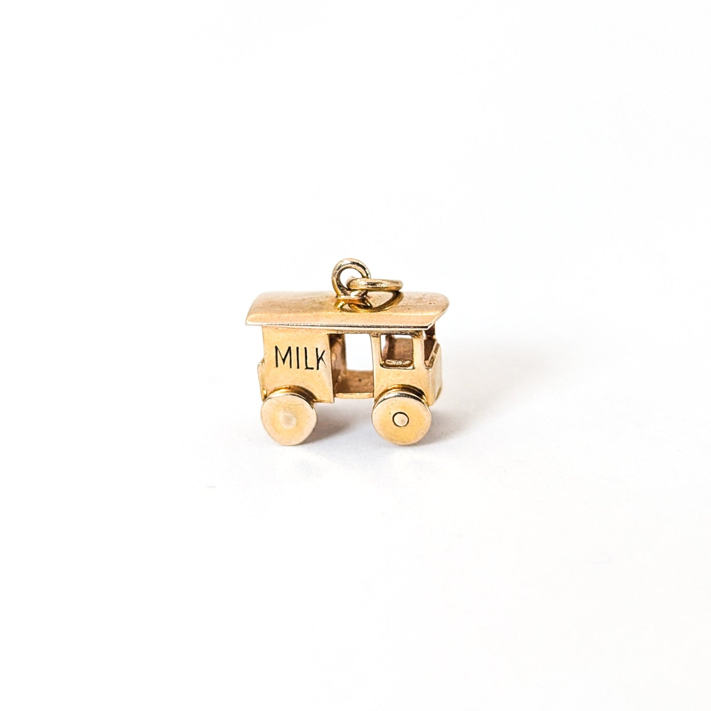 14K Gold milk cart mechanical charm on a white background