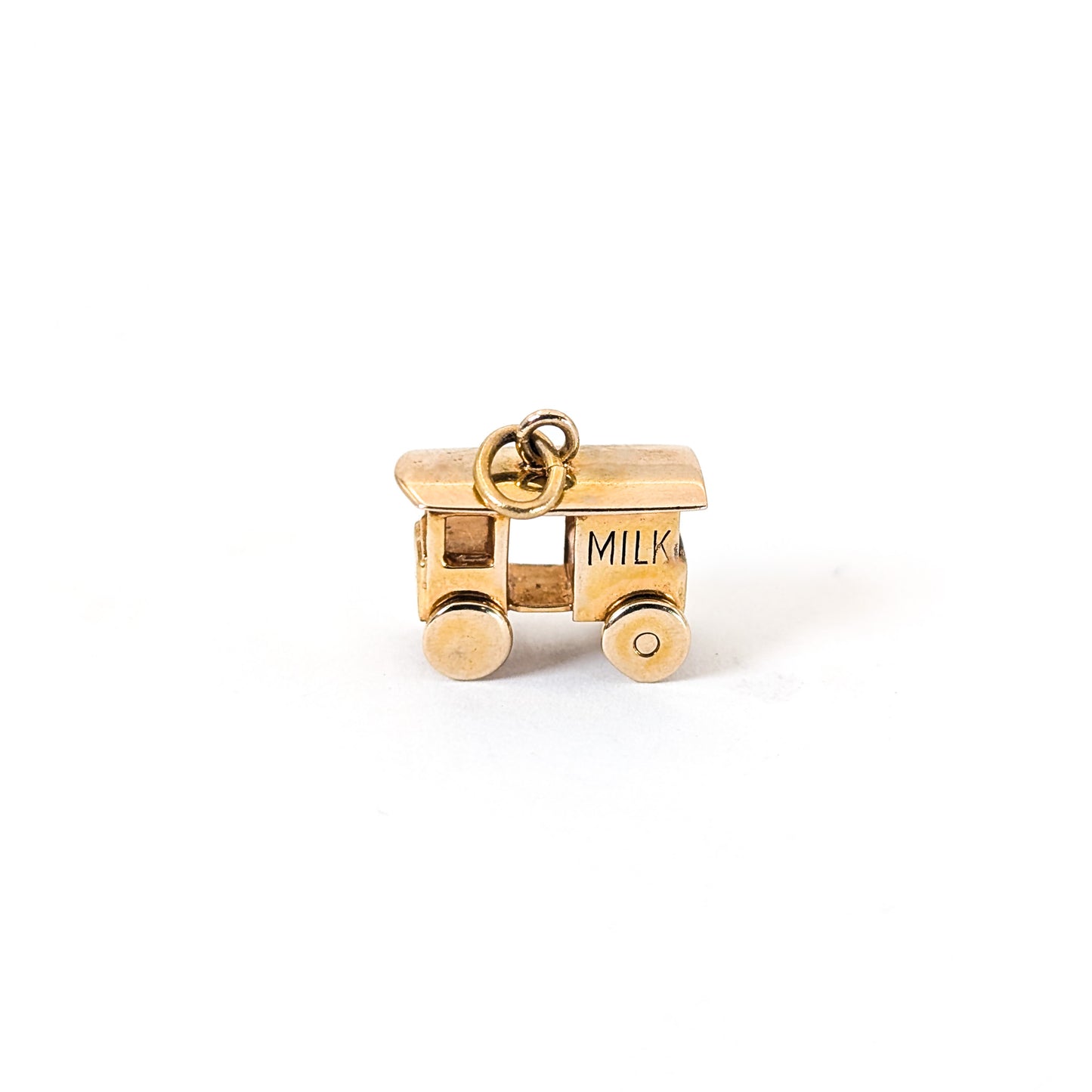 14K Gold milk cart mechanical charm on a white background