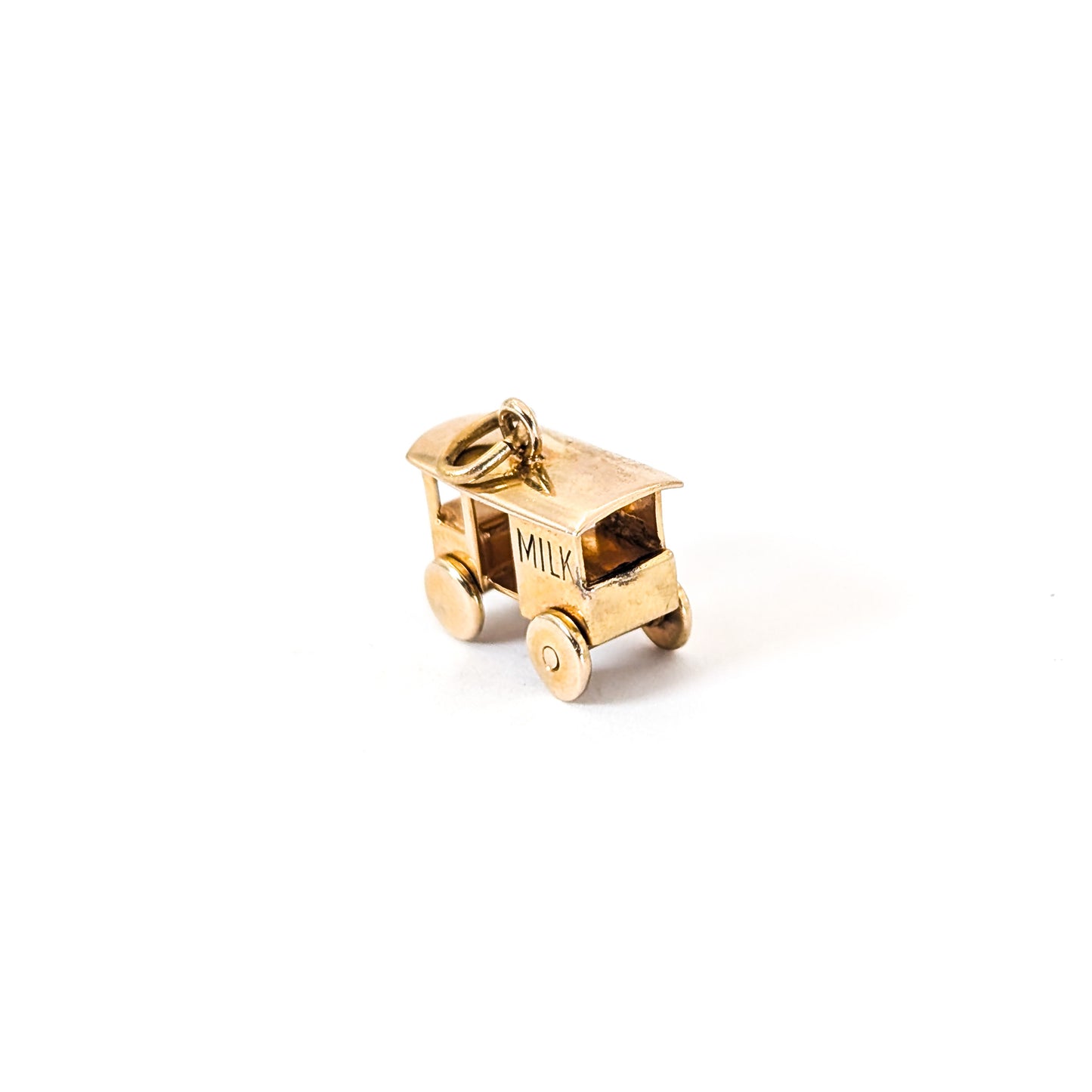 14K Gold milk cart mechanical charm on a white background