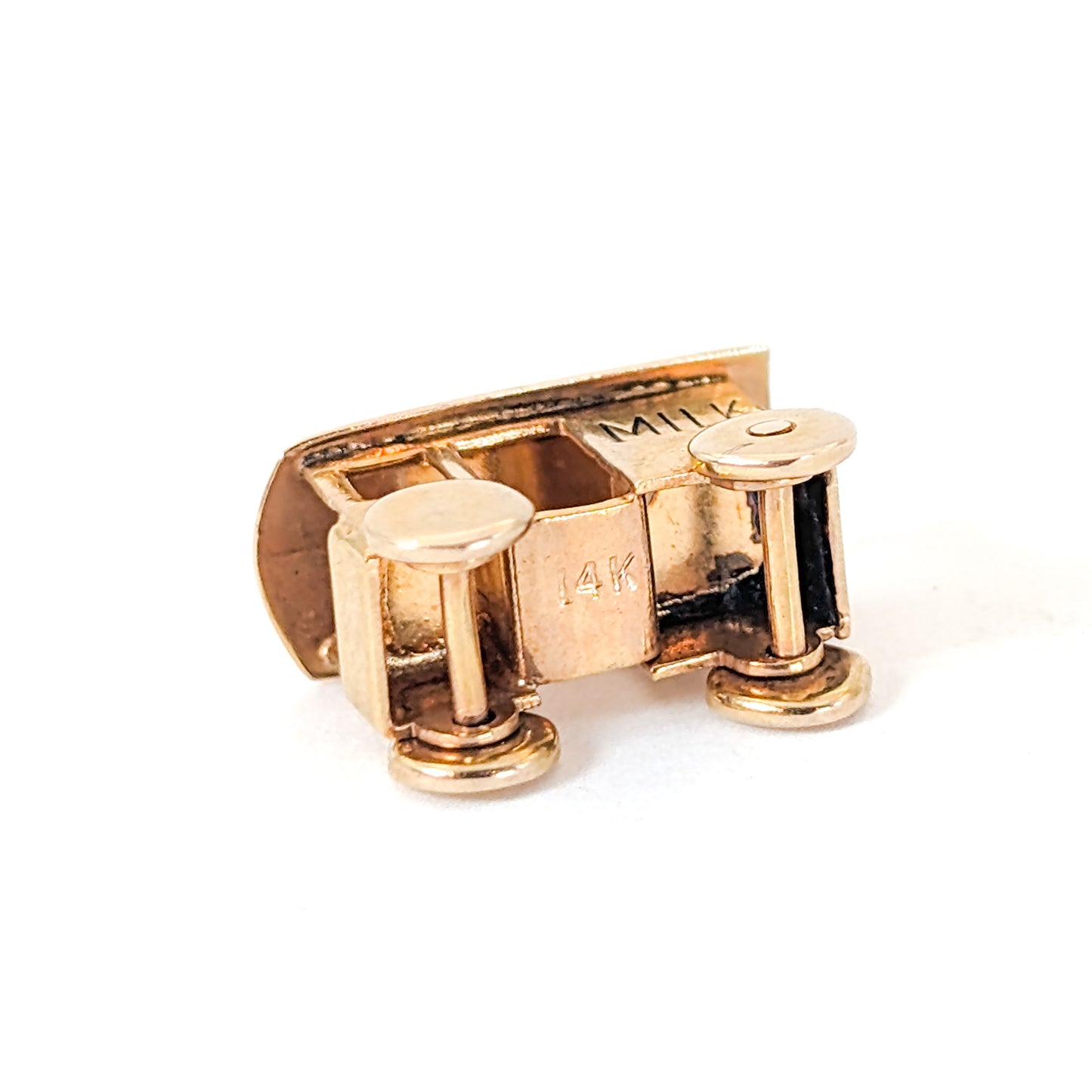 14K Gold milk cart mechanical charm on a white background
