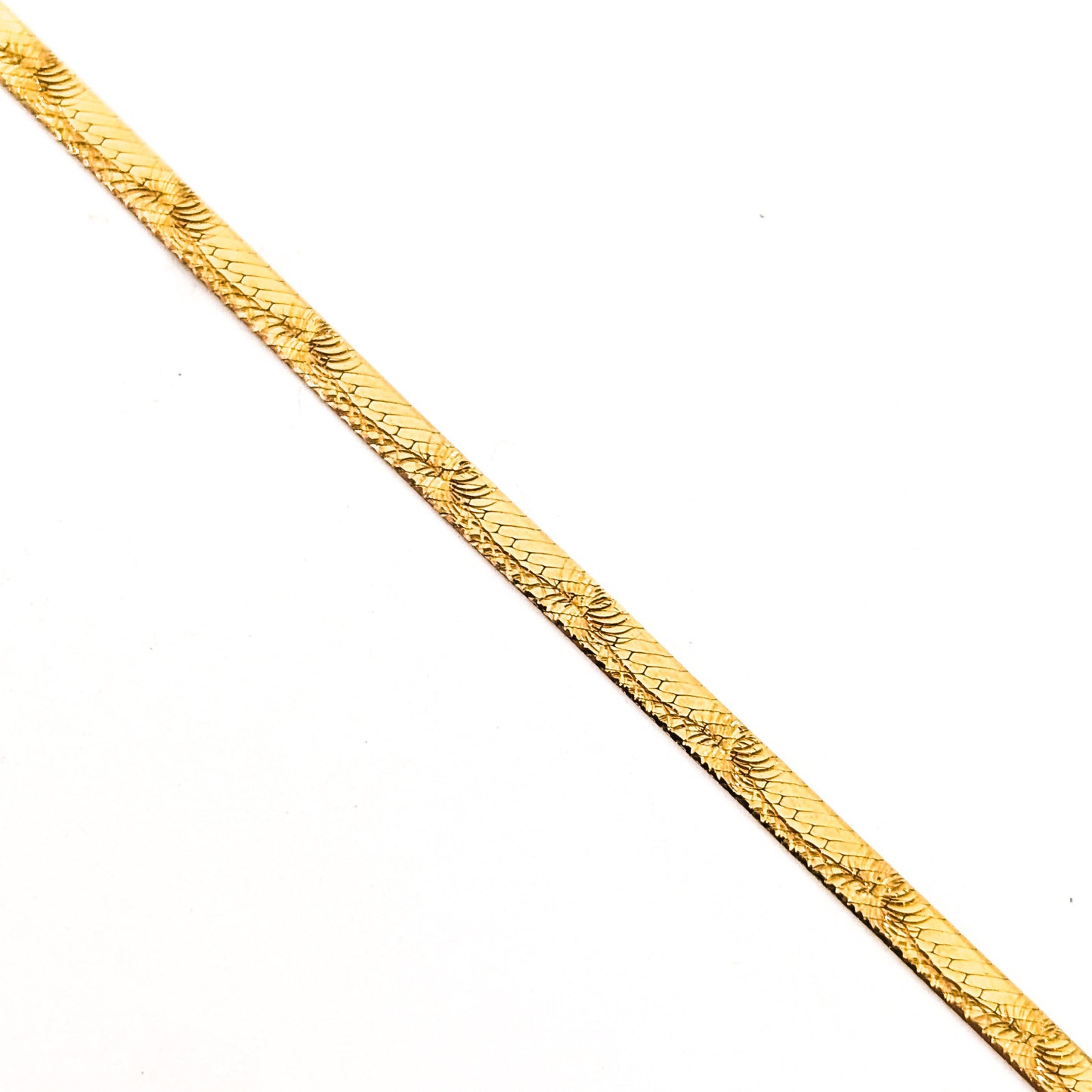 Vintage 14K gold bracelet features an elegant herringbone design with a textured finish on a white background