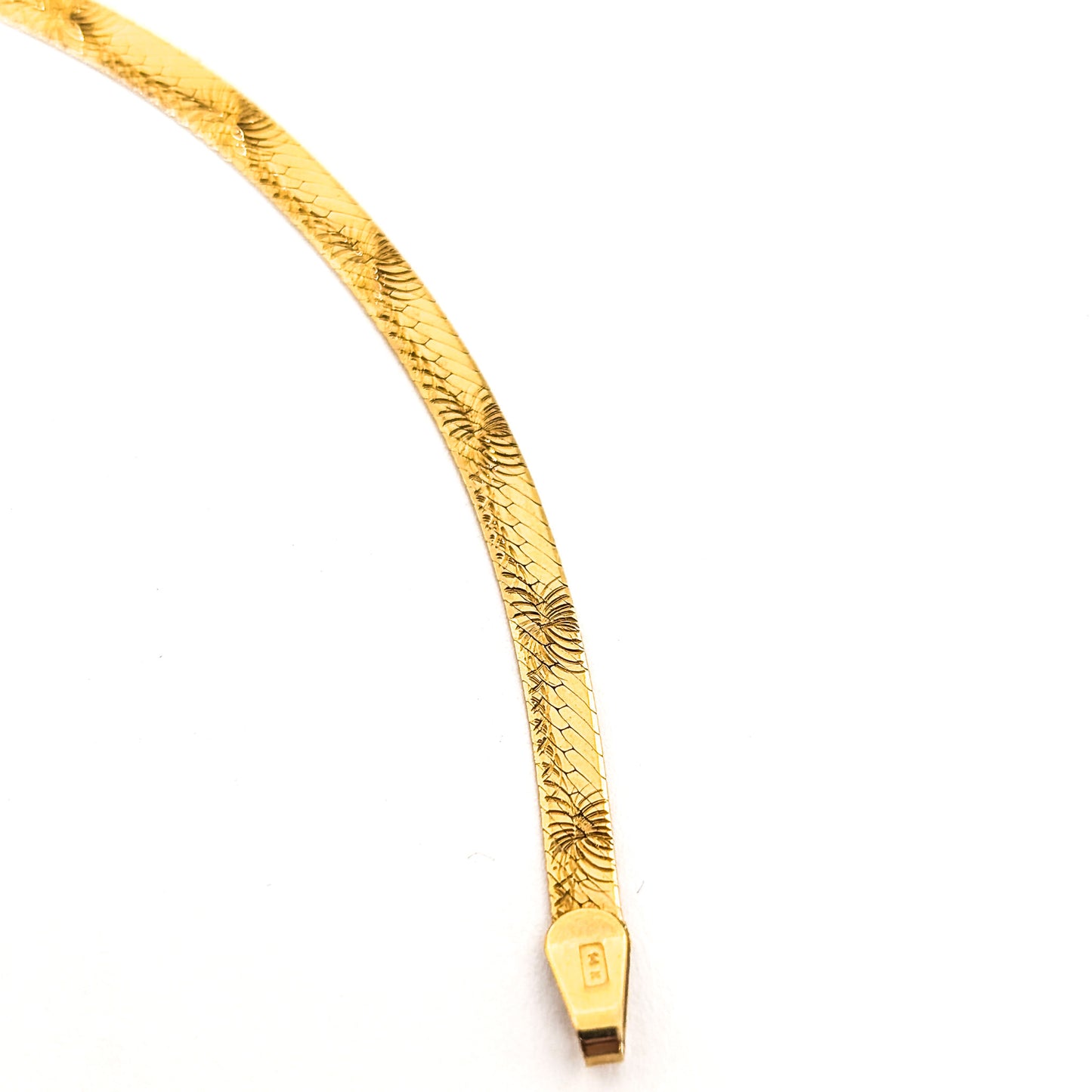 Vintage 14K gold bracelet features an elegant herringbone design with a textured finish on a white background
