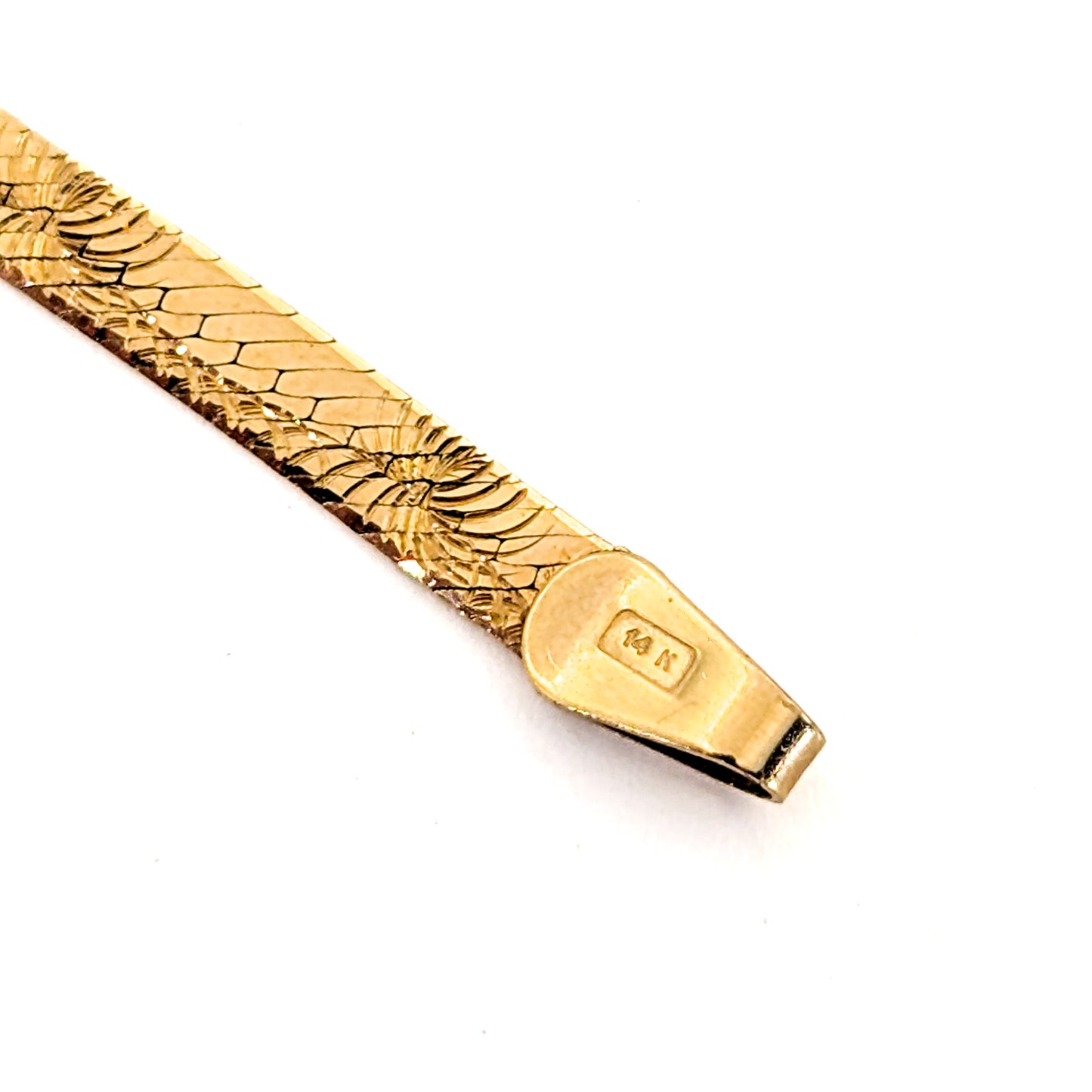 Vintage 14K gold bracelet features an elegant herringbone design with a textured finish on a white background
