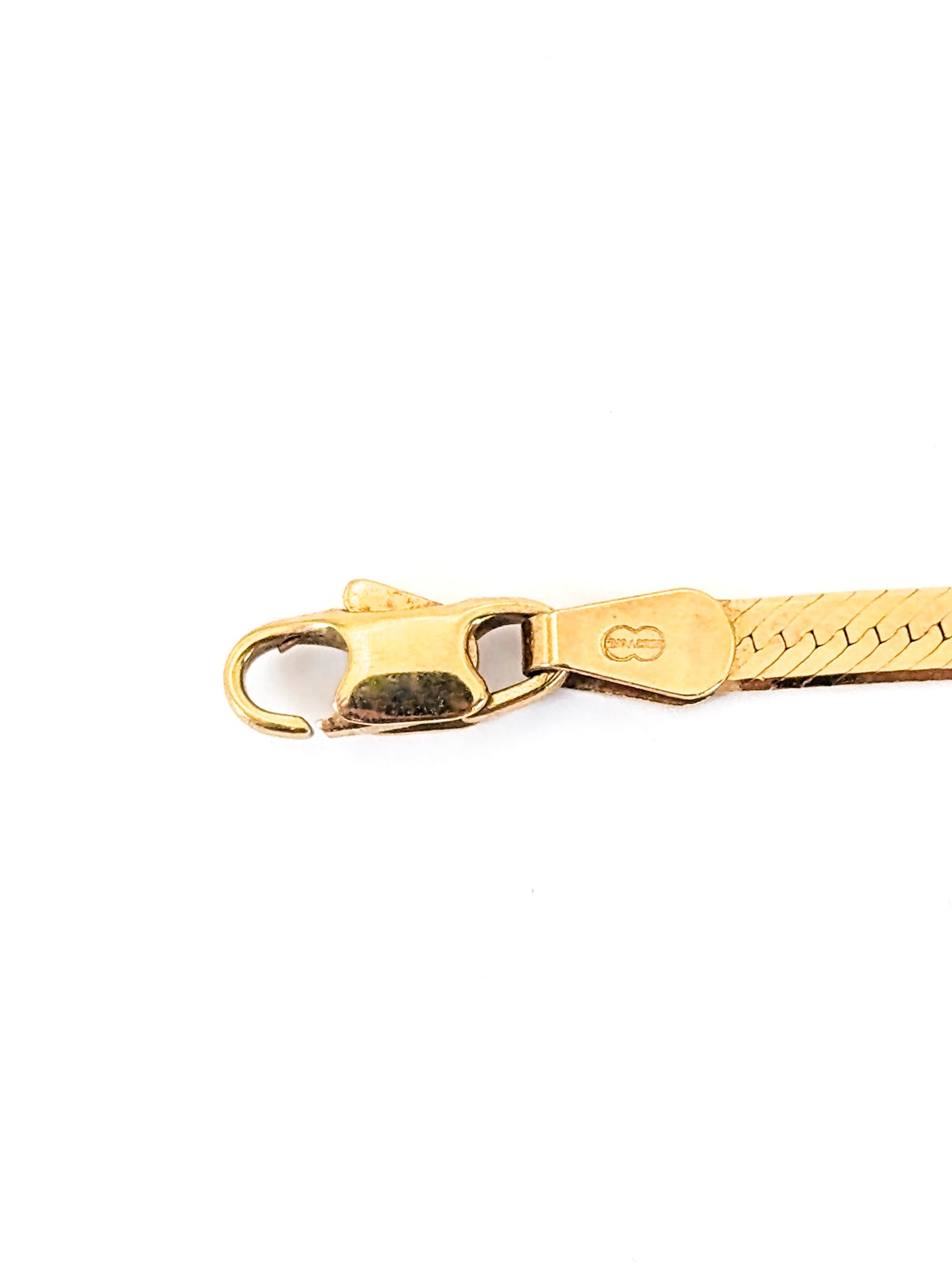 Vintage 14K gold bracelet features an elegant herringbone design with a textured finish on a white background