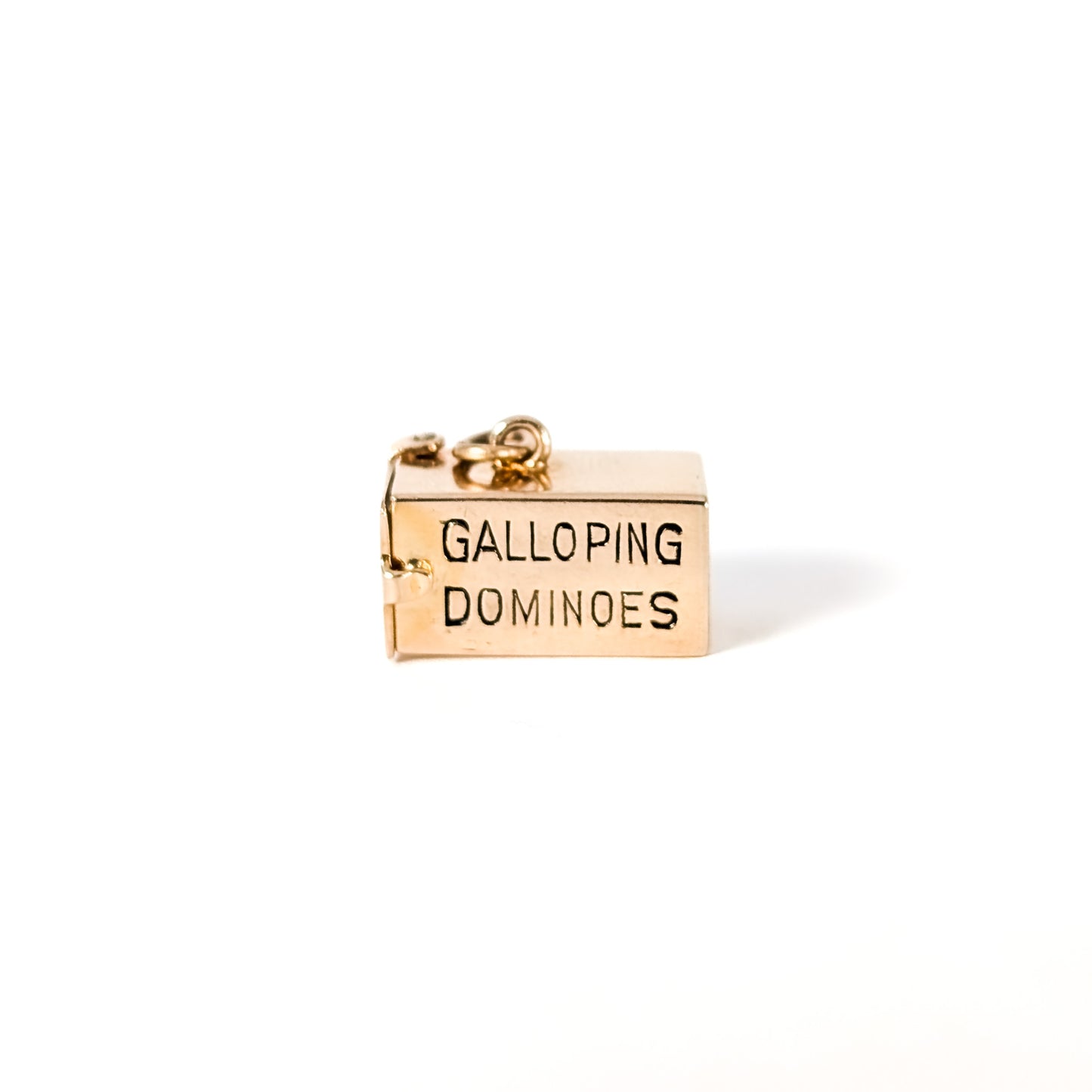 14K Gold mechanical charm pendent with 'Galloping Dominoes' text and with hidden Bakelite dice on a white background