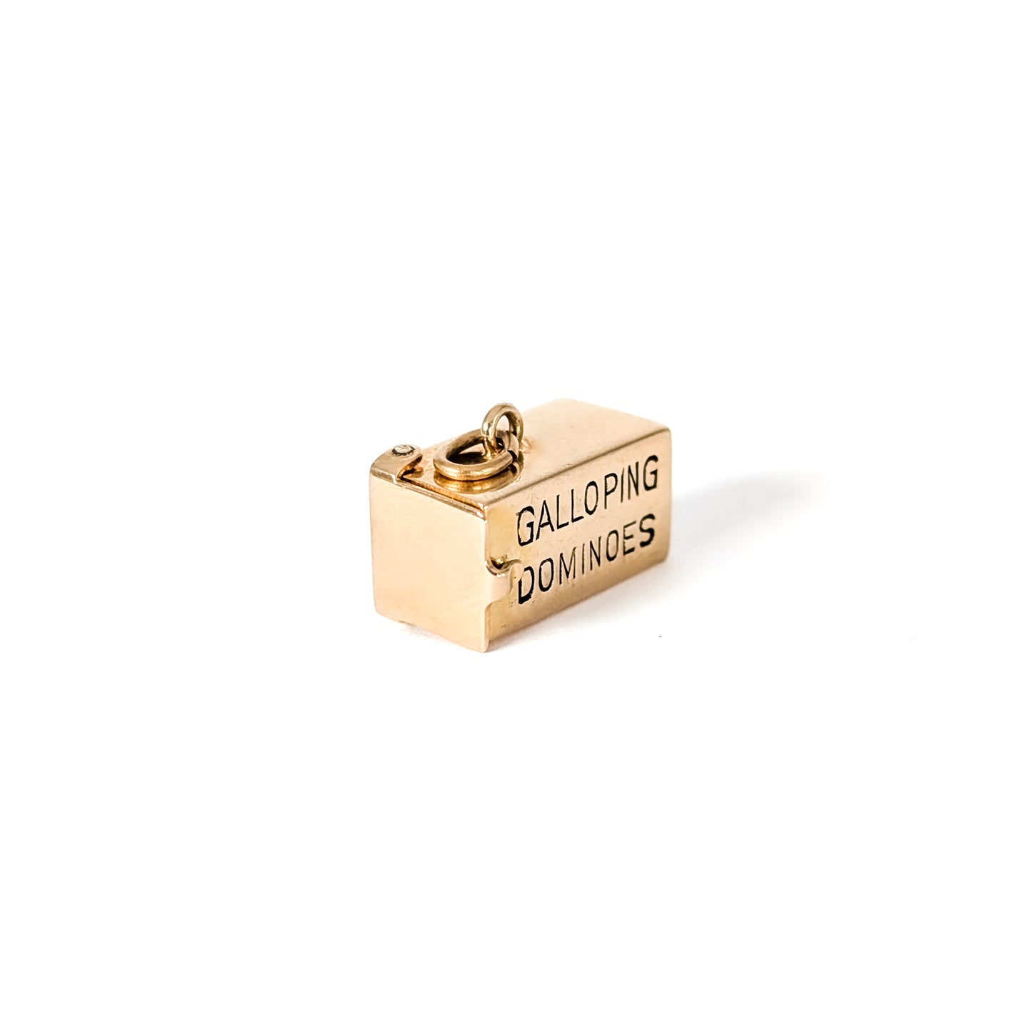 14K Gold mechanical charm pendent with 'Galloping Dominoes' text and with hidden Bakelite dice on a white background