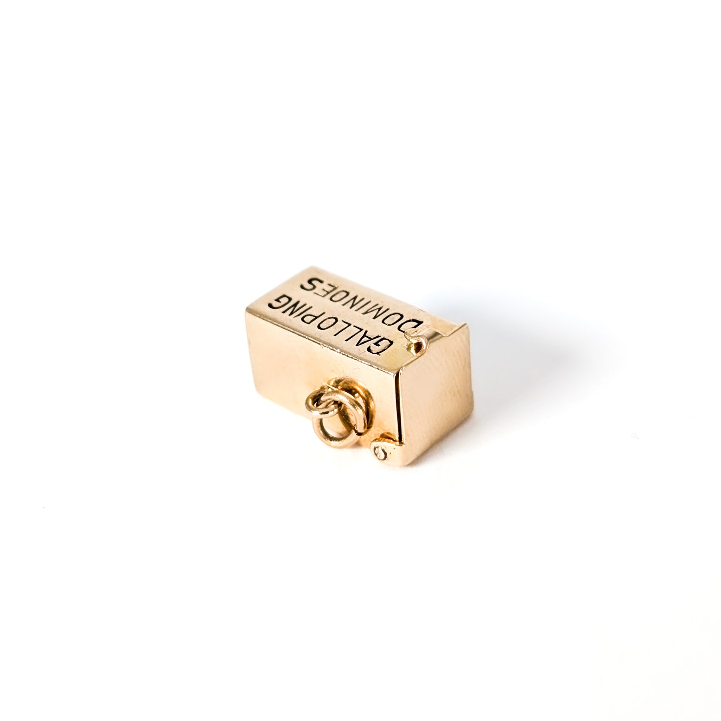 14K Gold mechanical charm pendent with 'Galloping Dominoes' text and with hidden Bakelite dice on a white background