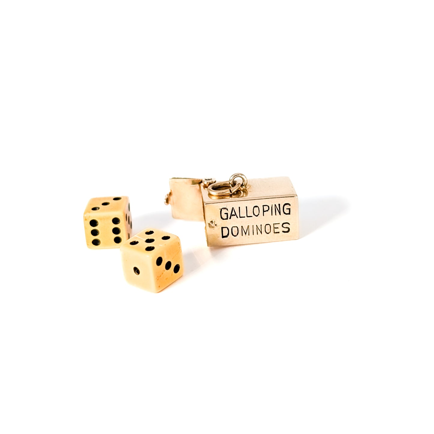 14K Gold mechanical charm pendent with 'Galloping Dominoes' text and with hidden Bakelite dice on a white background
