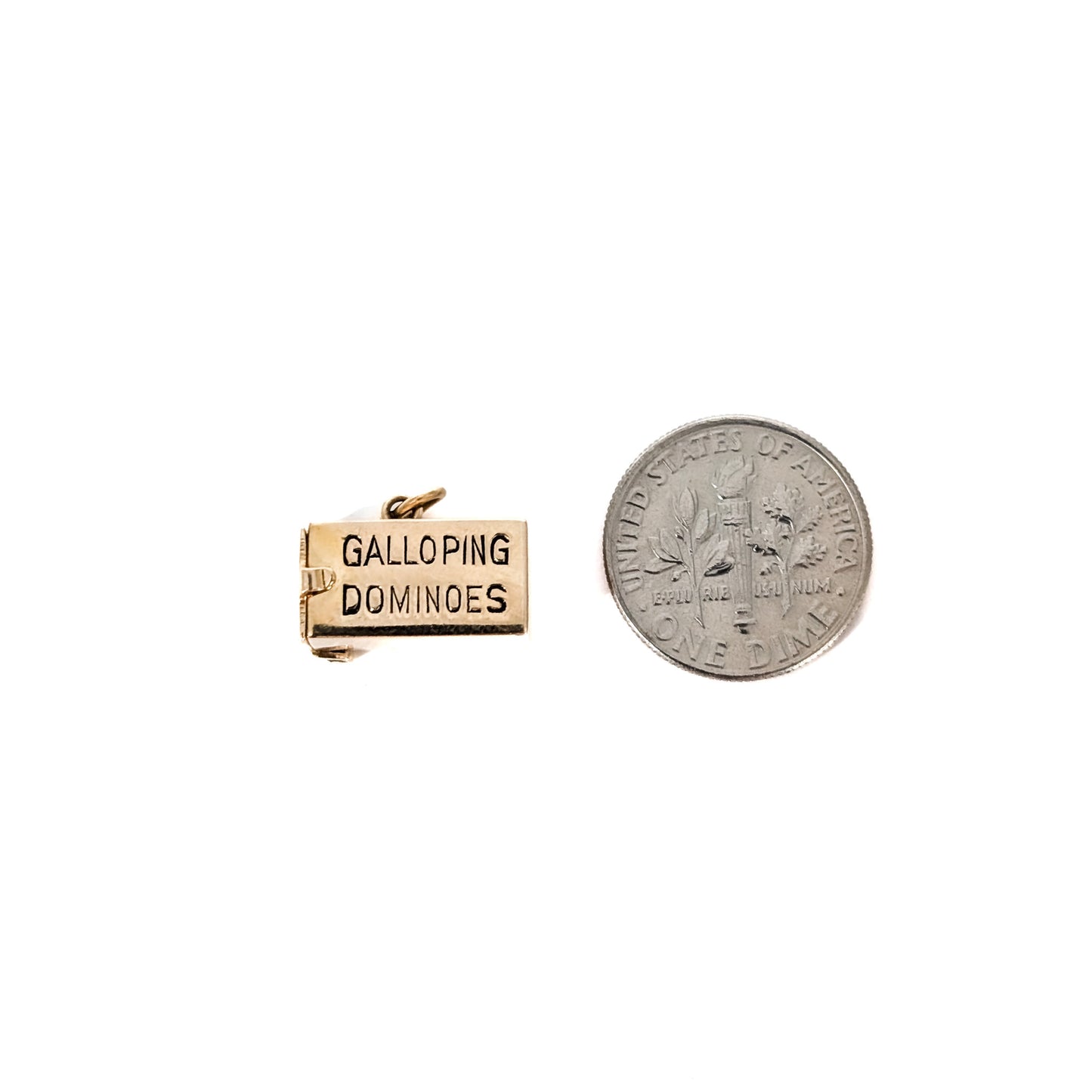 14K Gold mechanical charm pendent with 'Galloping Dominoes' text and with hidden Bakelite dice on a white background