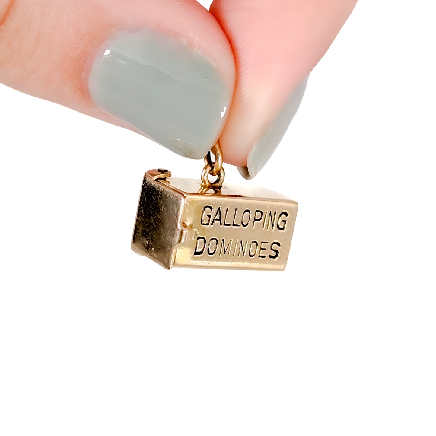 14K Gold mechanical charm pendent with 'Galloping Dominoes' text and with hidden Bakelite dice on a white background