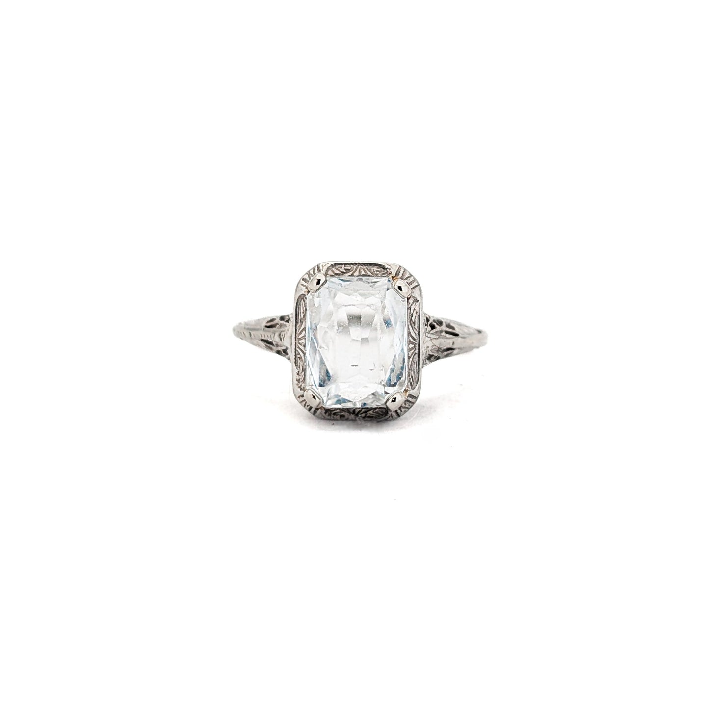 18k white gold ring with a rectangular aquamarine gemstone on a white background