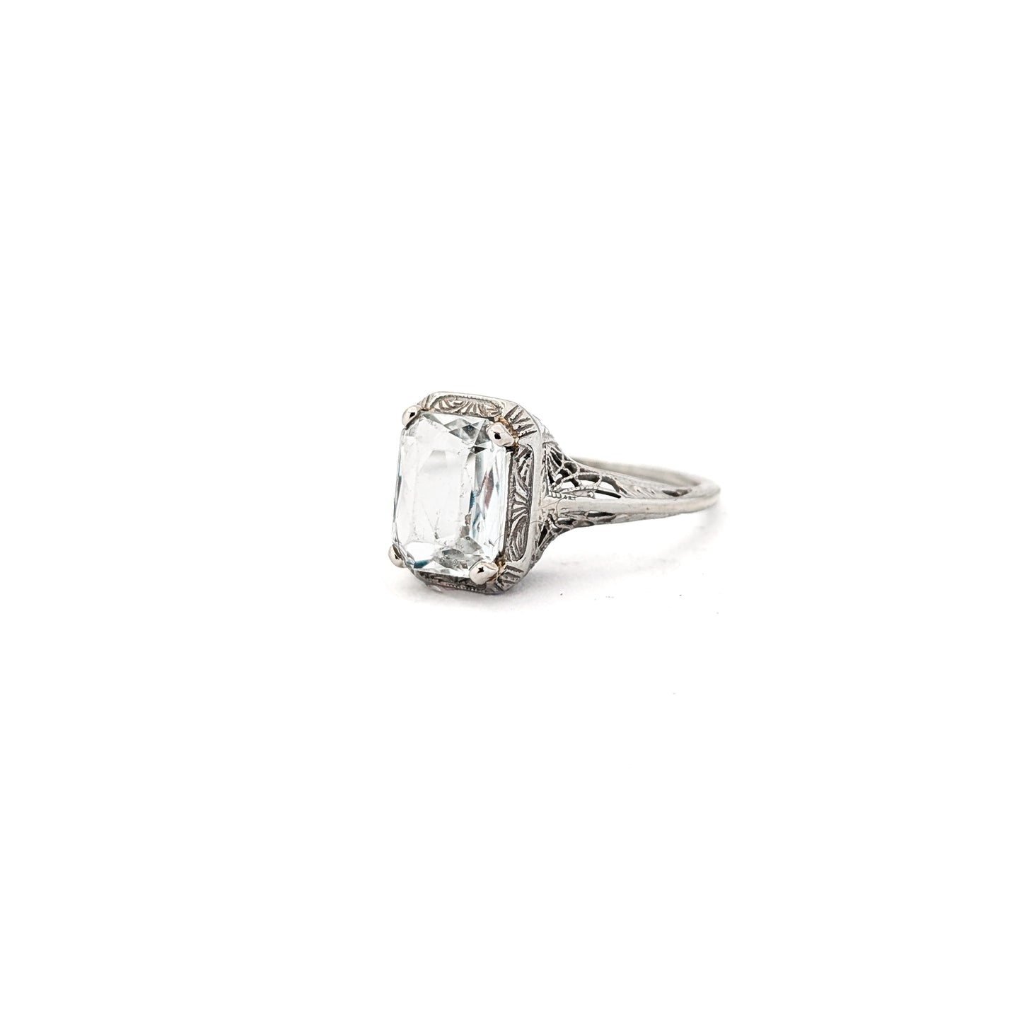 18k white gold ring with a rectangular aquamarine gemstone on a white background