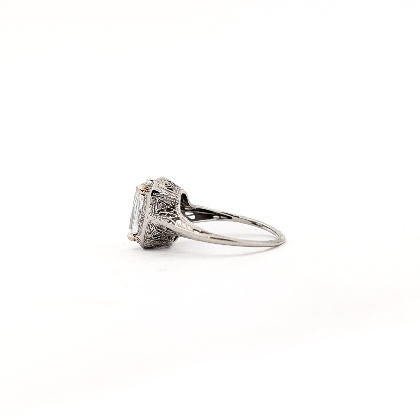 18k white gold ring with a rectangular aquamarine gemstone on a white background