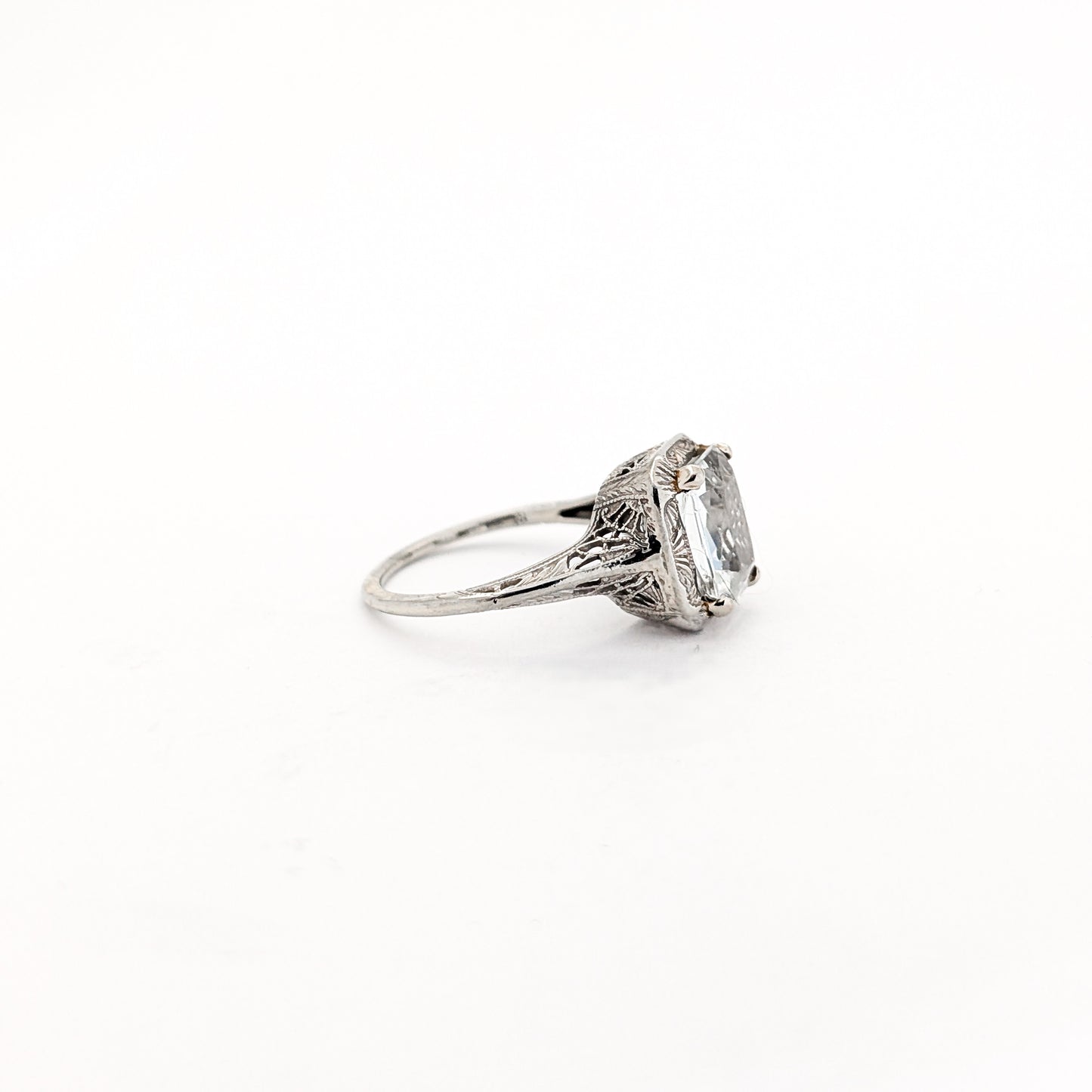 18k white gold ring with a rectangular aquamarine gemstone on a white background