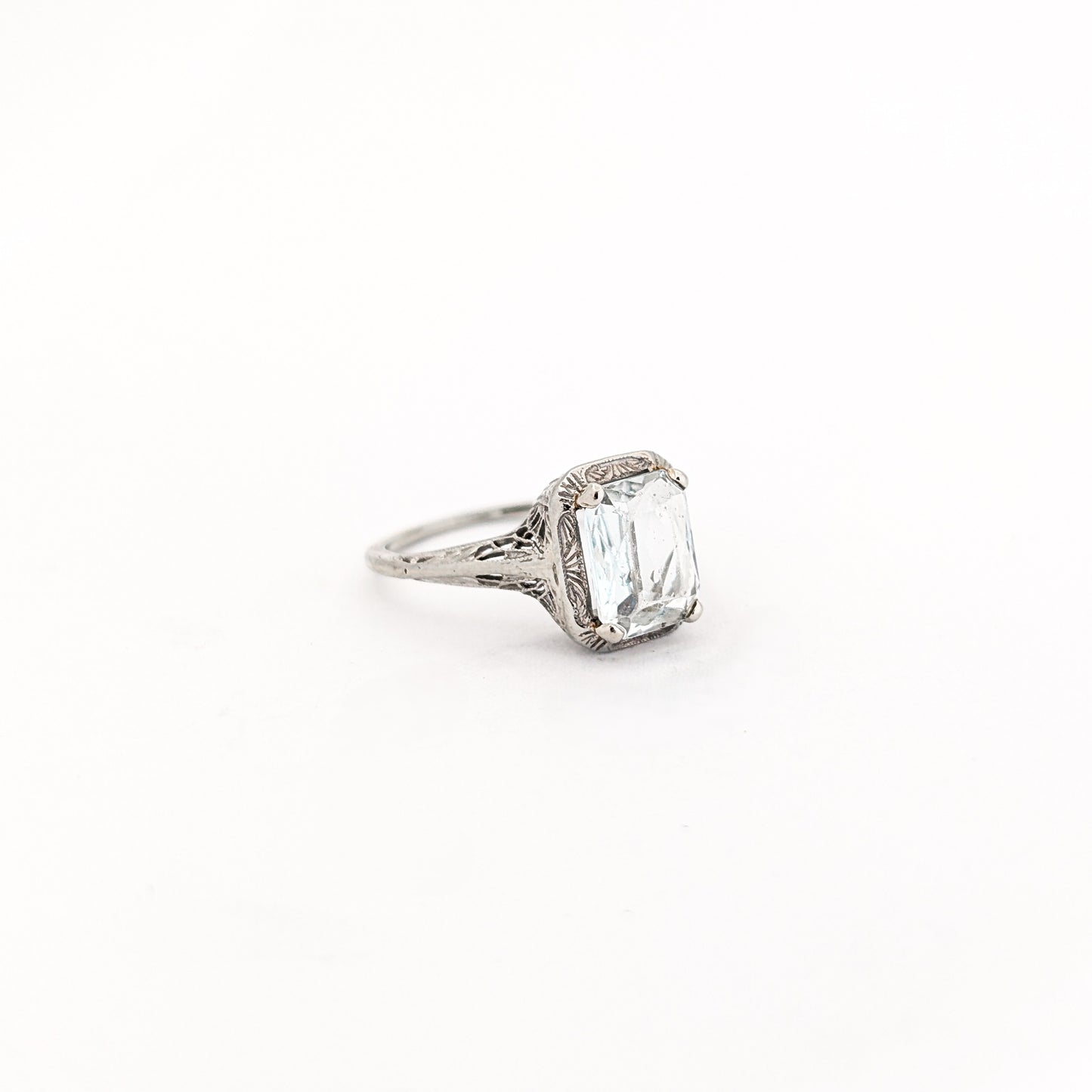 18k white gold ring with a rectangular aquamarine gemstone on a white background