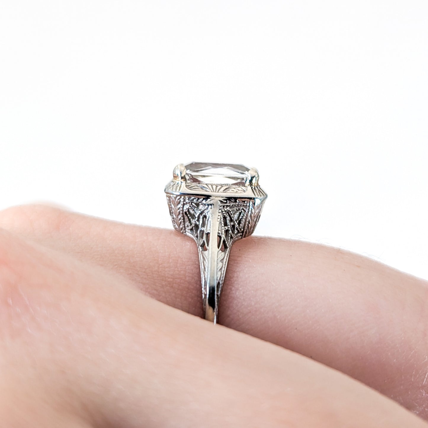 18k white gold ring with a rectangular aquamarine gemstone on a white background