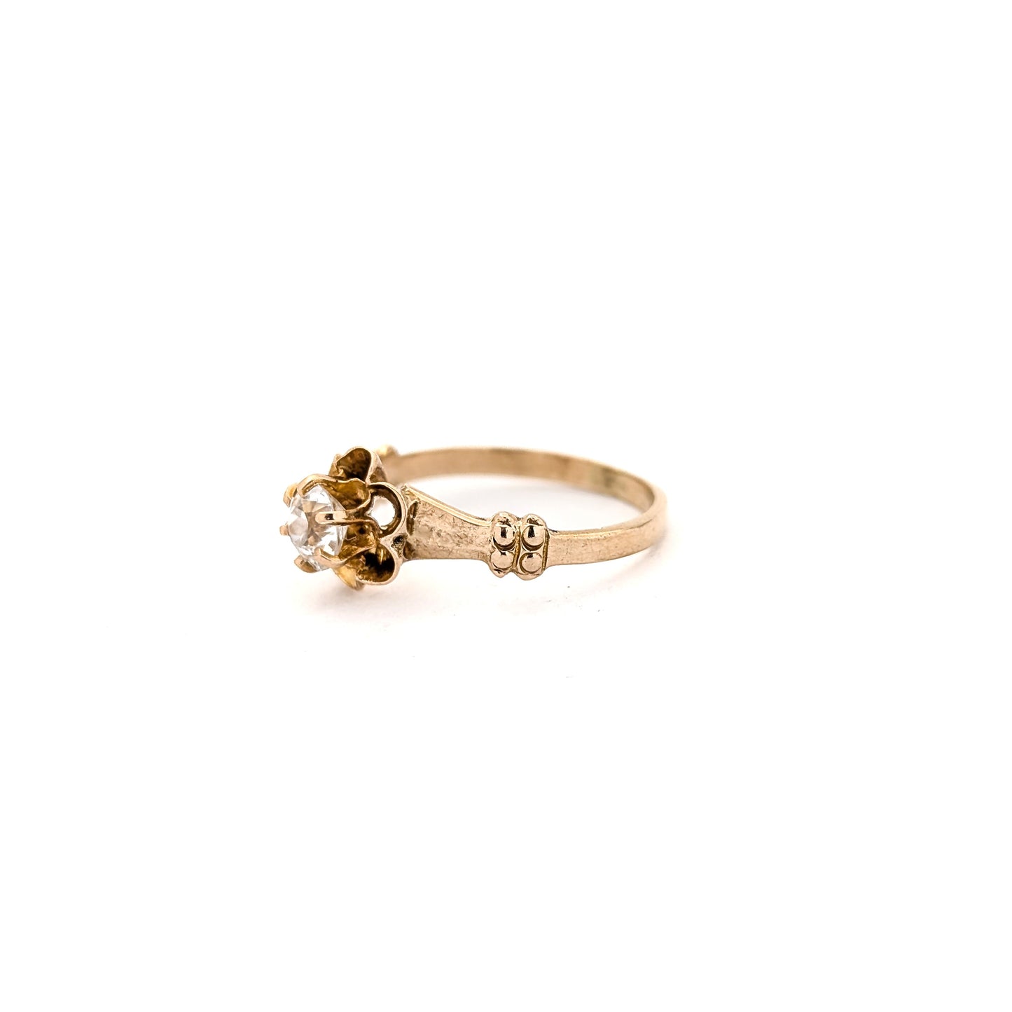 10k Gold ring with a diamond on a white background