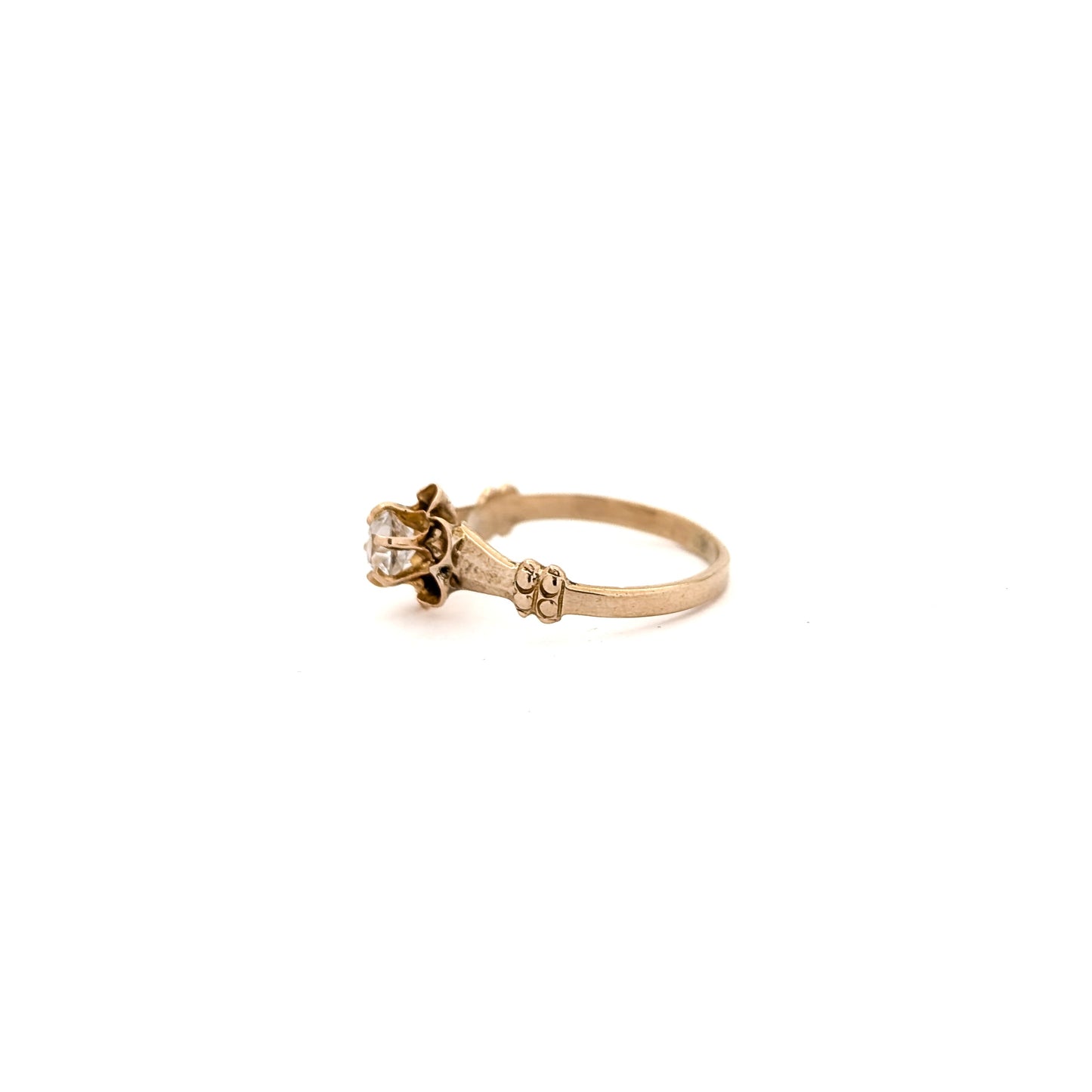 10k Gold ring with a diamond on a white background