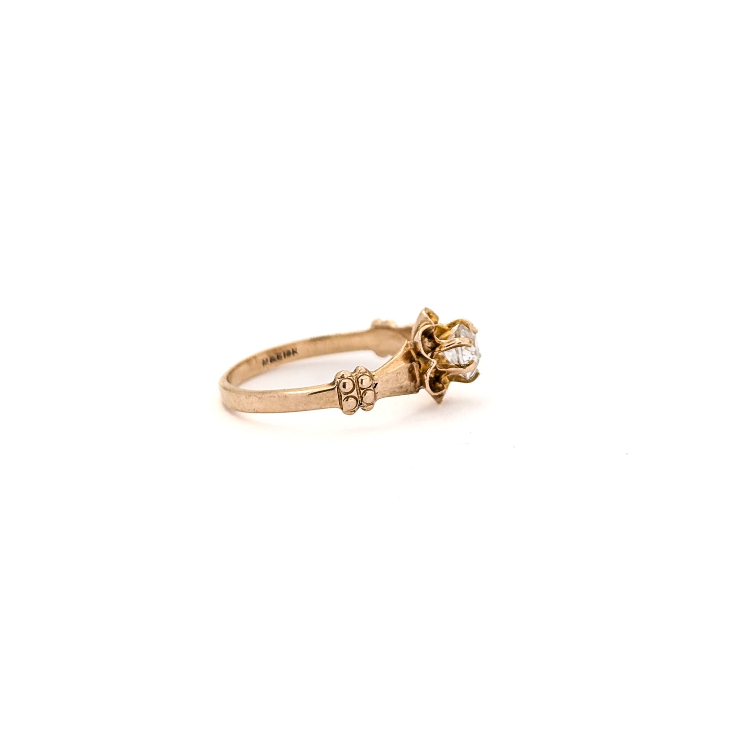 10k Gold ring with a diamond on a white background