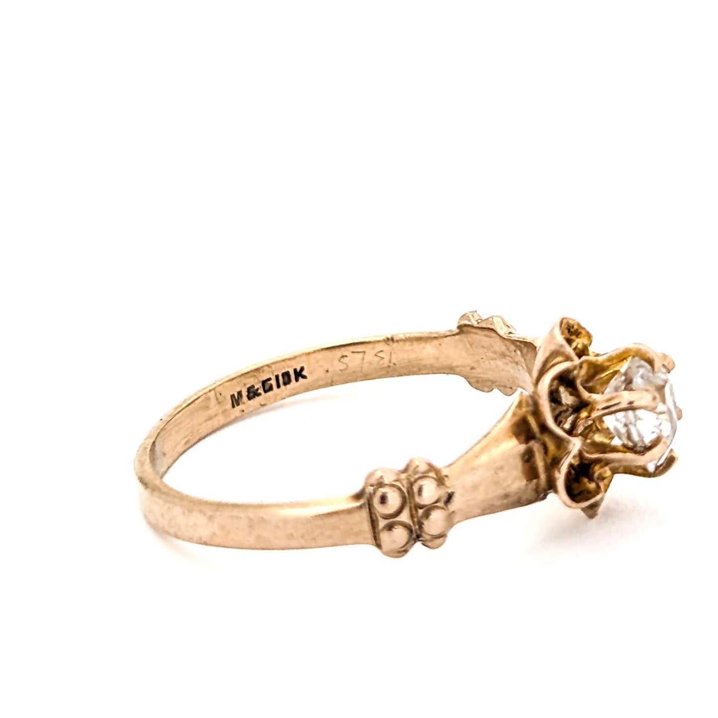 10k Gold ring with a diamond on a white background