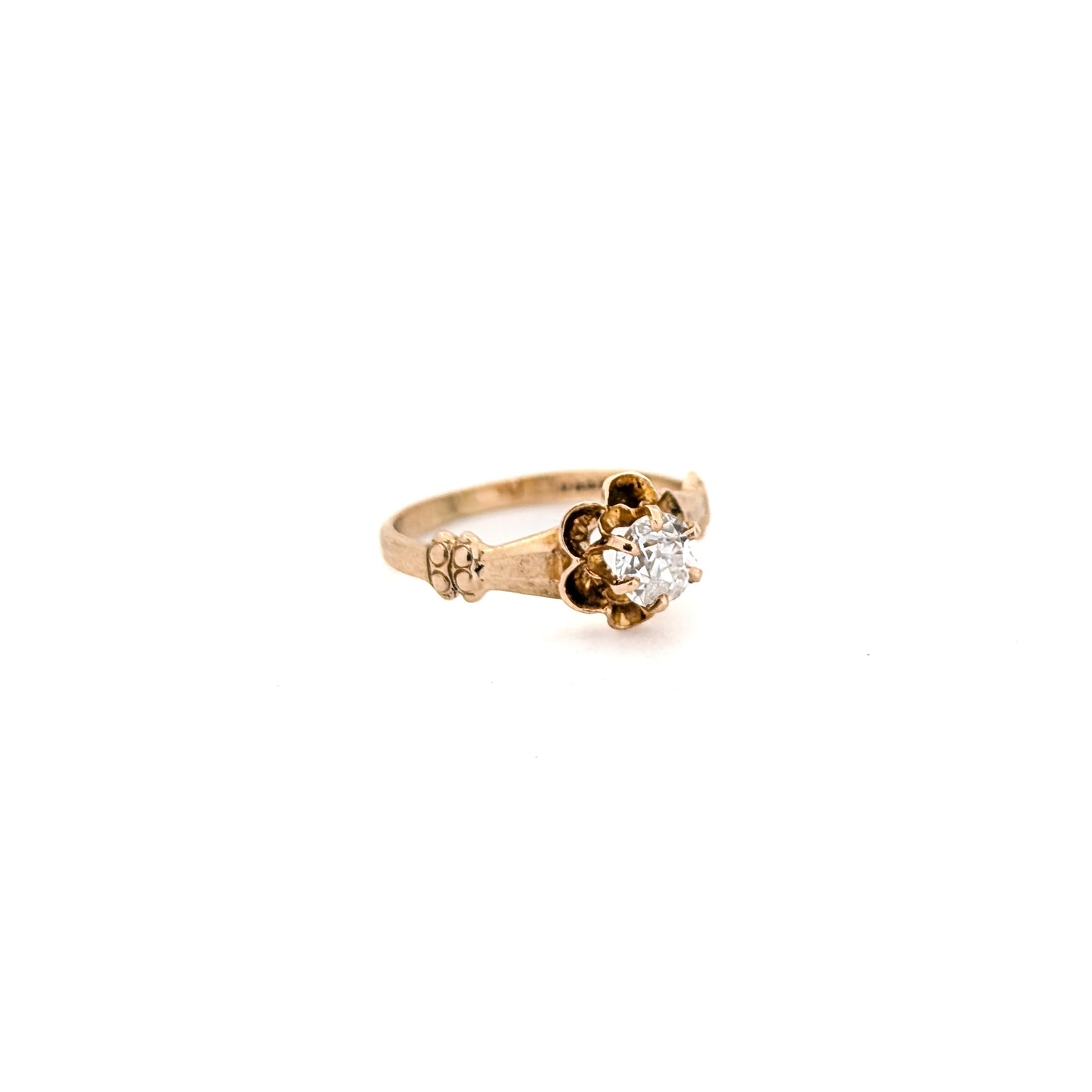 10k Gold ring with a diamond on a white background