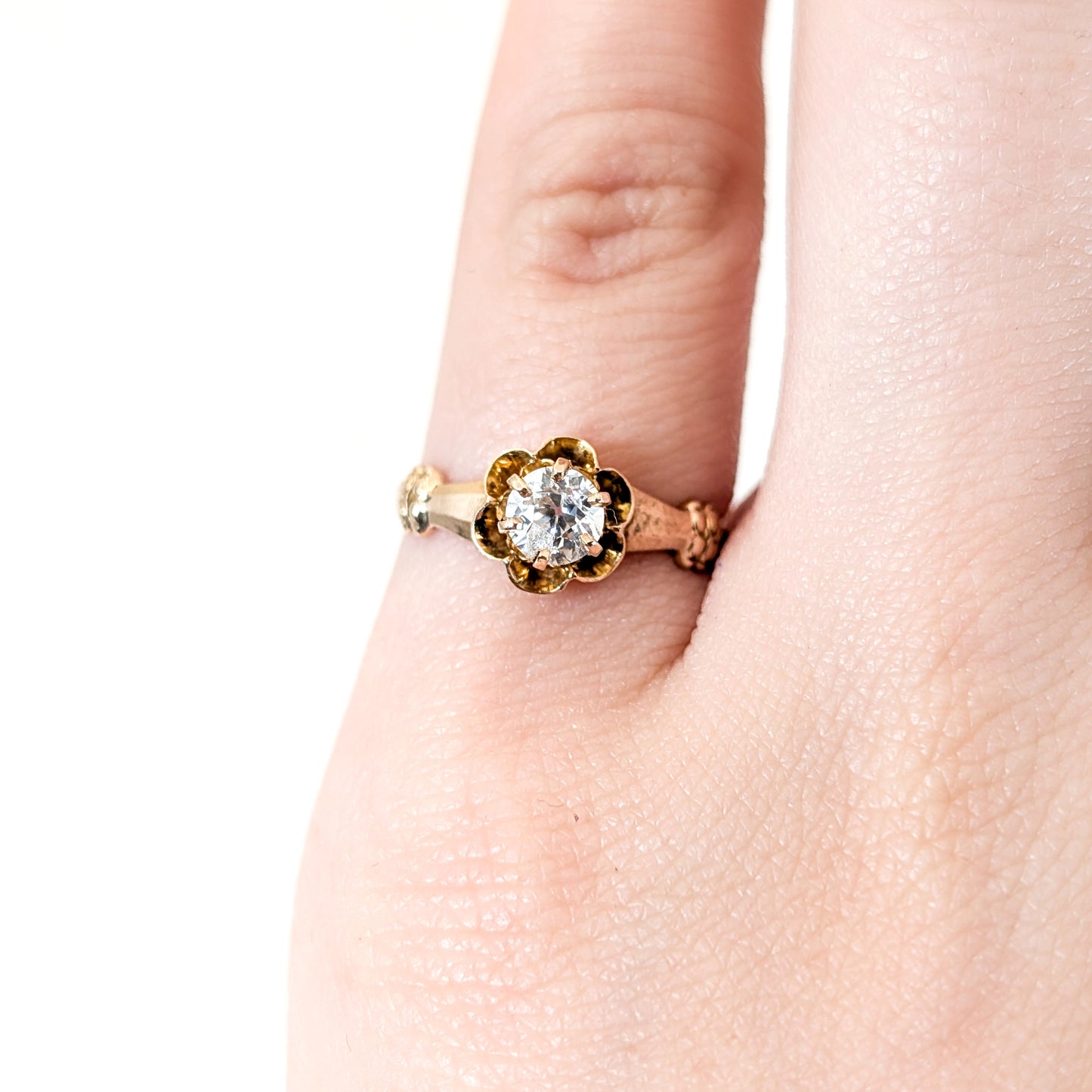 10k Gold ring with a diamond on a white background